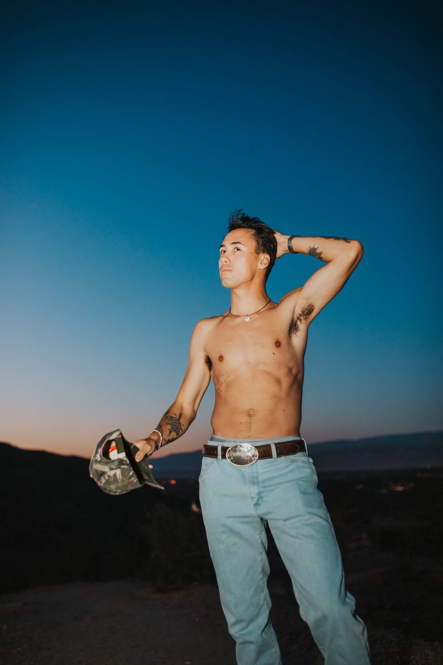 Isaak Rowe posing outdoors beneath a blue Palm Springs sky
