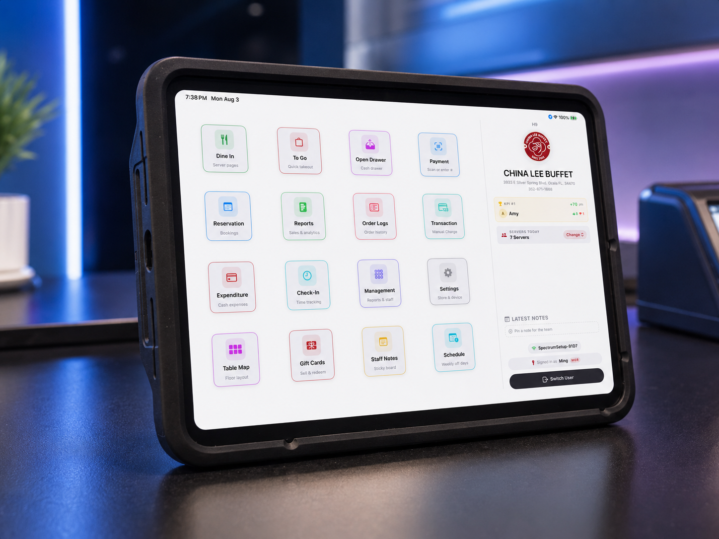 Tablet screen displaying restaurant management software with various menu options including Dine In, To Go, Open Drawer, Payment, Reservation, Reports, Order Logs, Transaction, Expenditure, Check-In, Management, Settings, Table Map, Gift Cards, Staff Notes, Schedule, and Switch User. The site displayed is China Lee Buffet, with server information and recent notes.