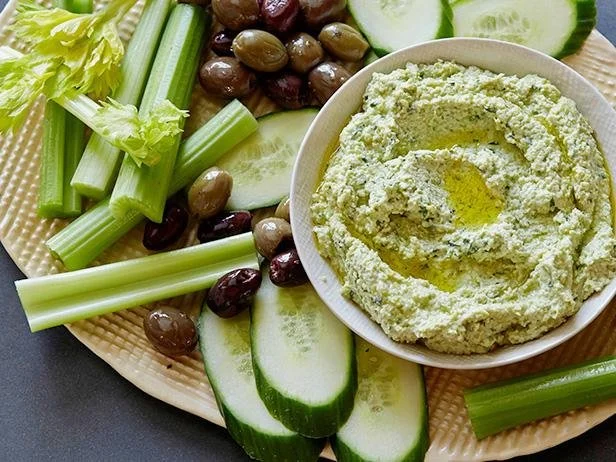  Mezze platter with hummus, vegetable crudite including cucumber and celery, and olives 