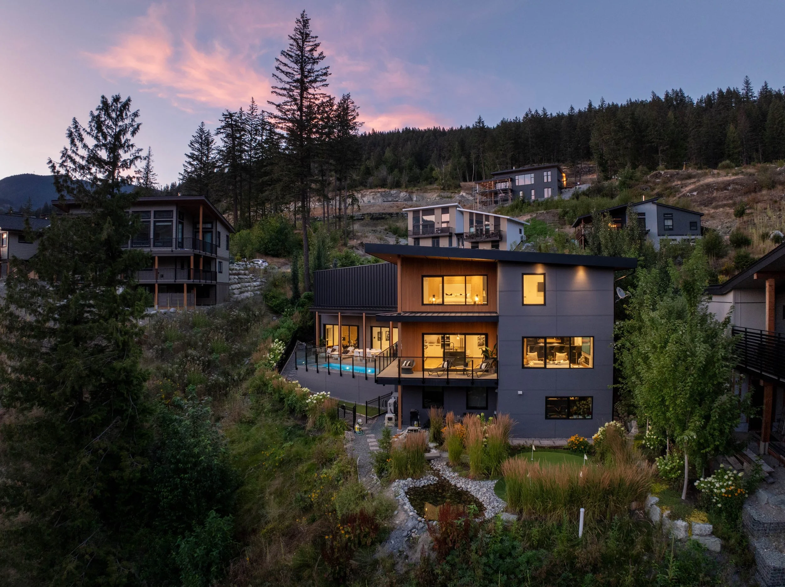 Modern custom home in Whistler built into a hillside, showcasing contemporary architecture and craftsmanship by a Sea to Sky home builder.