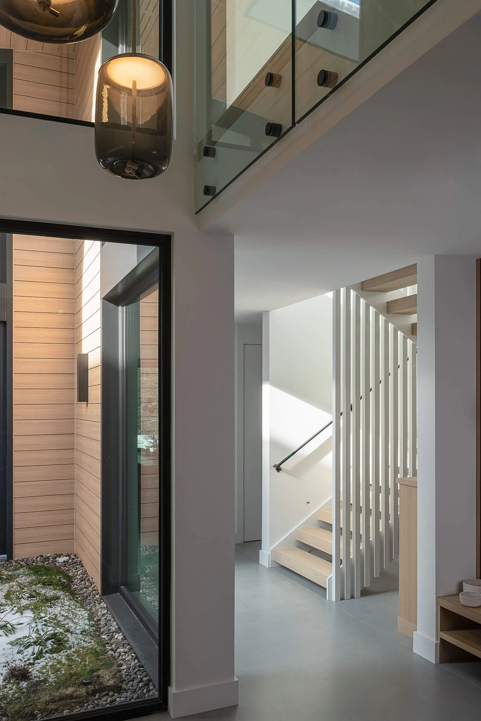 Modern custom home interior in the Sea to Sky region, showcasing natural light, wood detailing, and thoughtful design by a Whistler and Pemberton home builder.