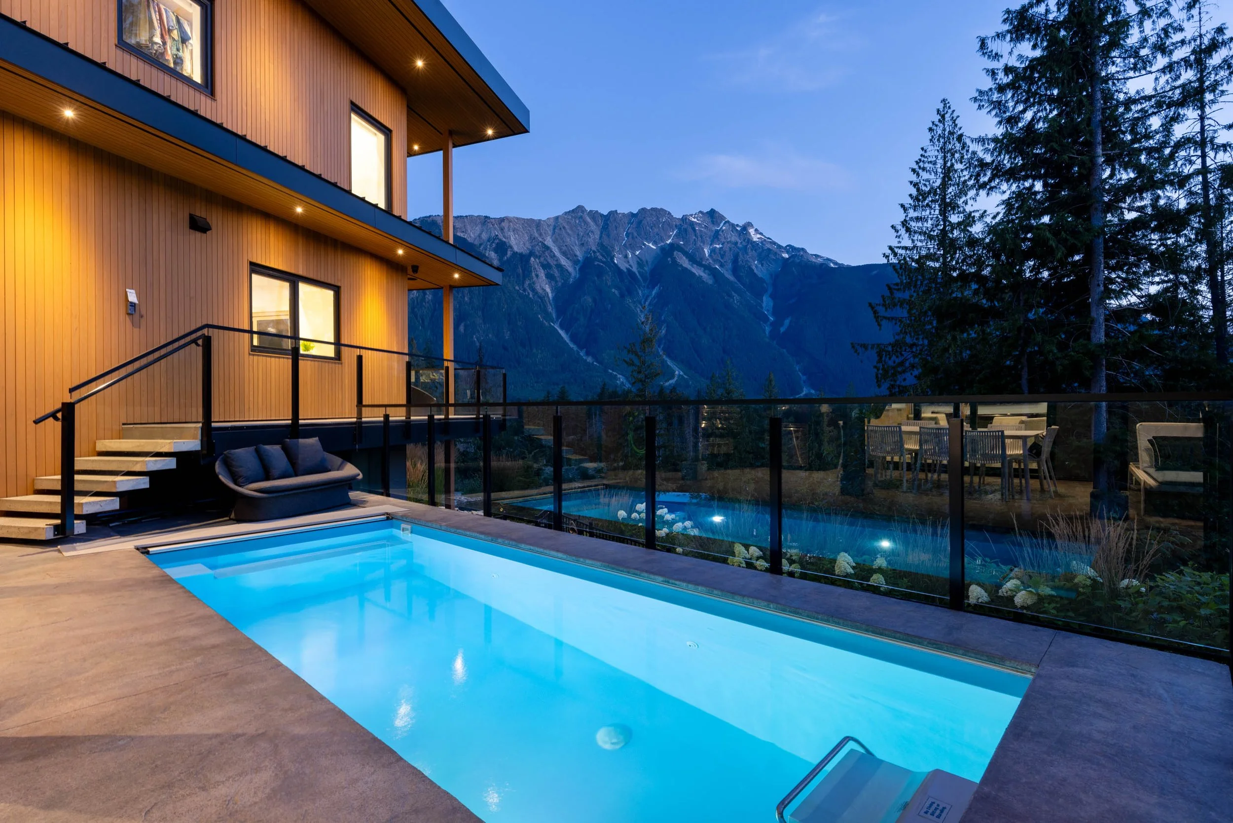 Cerulean custom home in Pemberton at dusk — mountain contemporary design by Balmoral Construction