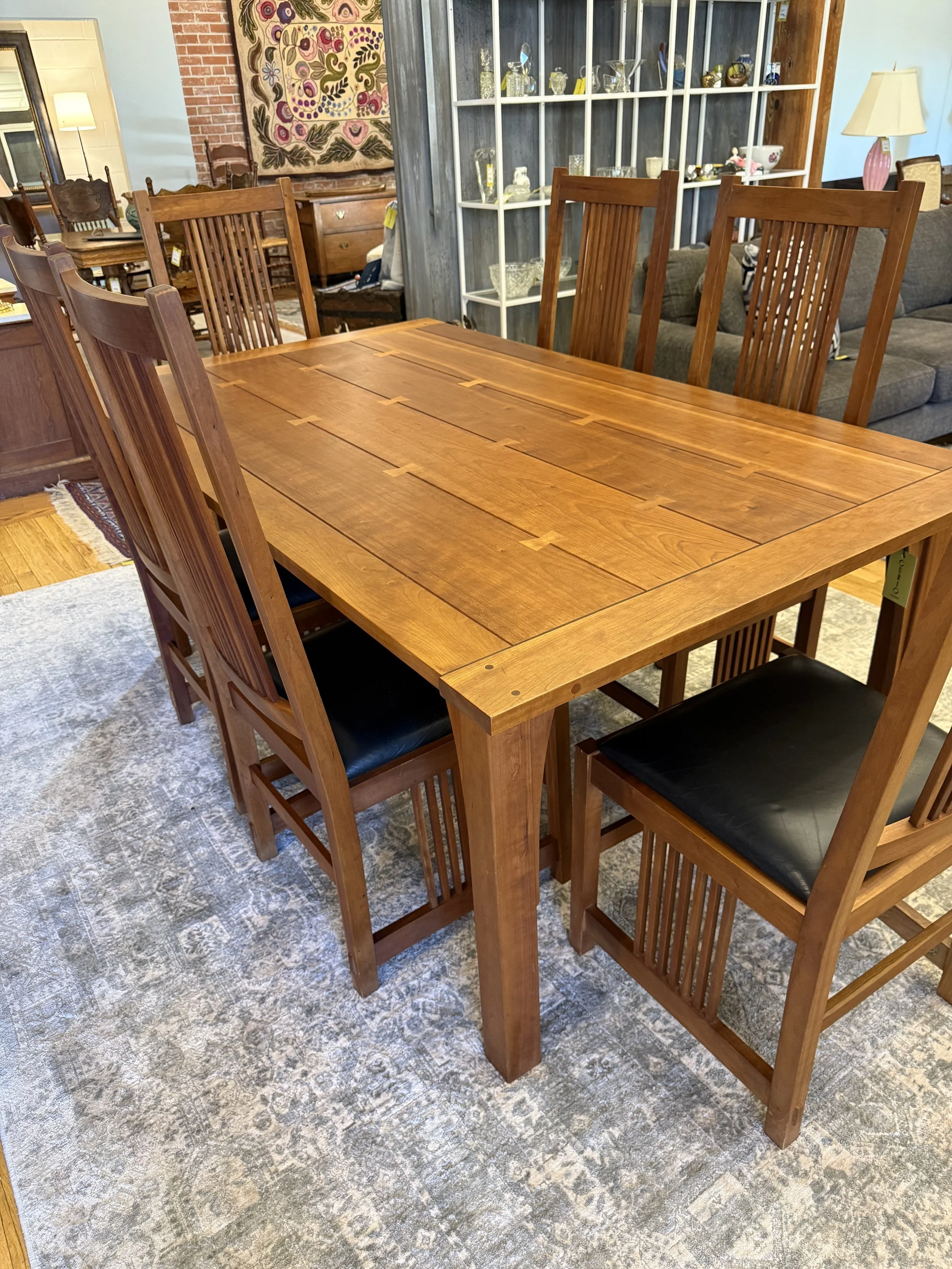 Stickley mission oak dining table with butterfly inlays 6' x 42" and six matching slatted back chairs with mat black leather seats 
