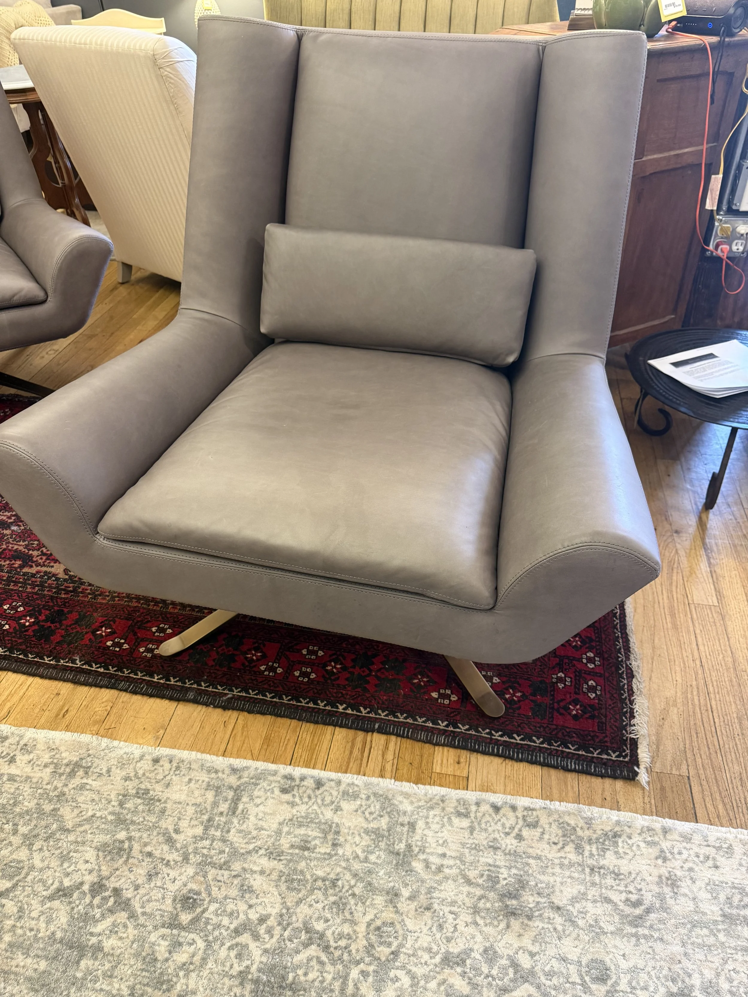Pair of leather swivel accent chairs from RH- Luke Contoured wingback design, flared arms, 4 pronged metal feet 