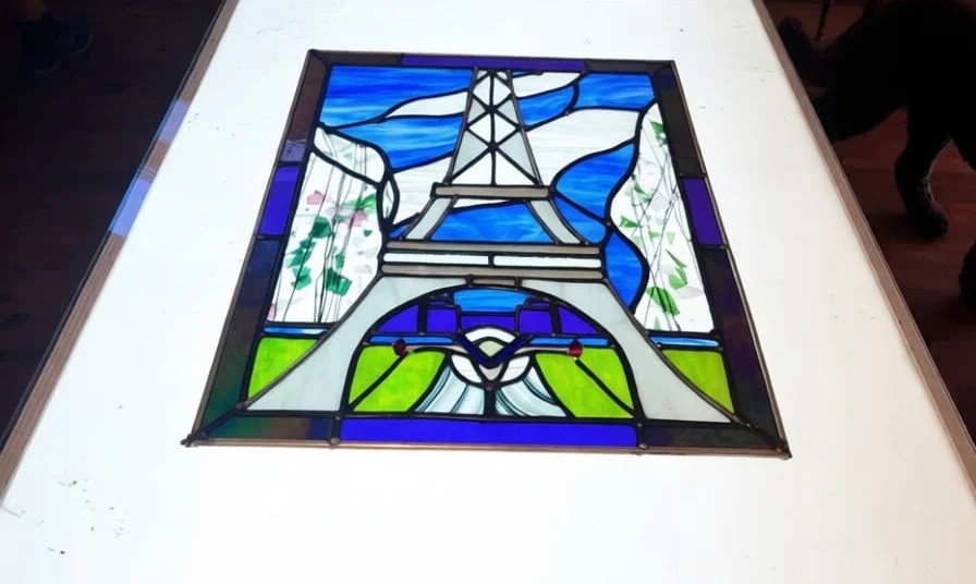 Eiffel Tower stained glass panel on workshop table