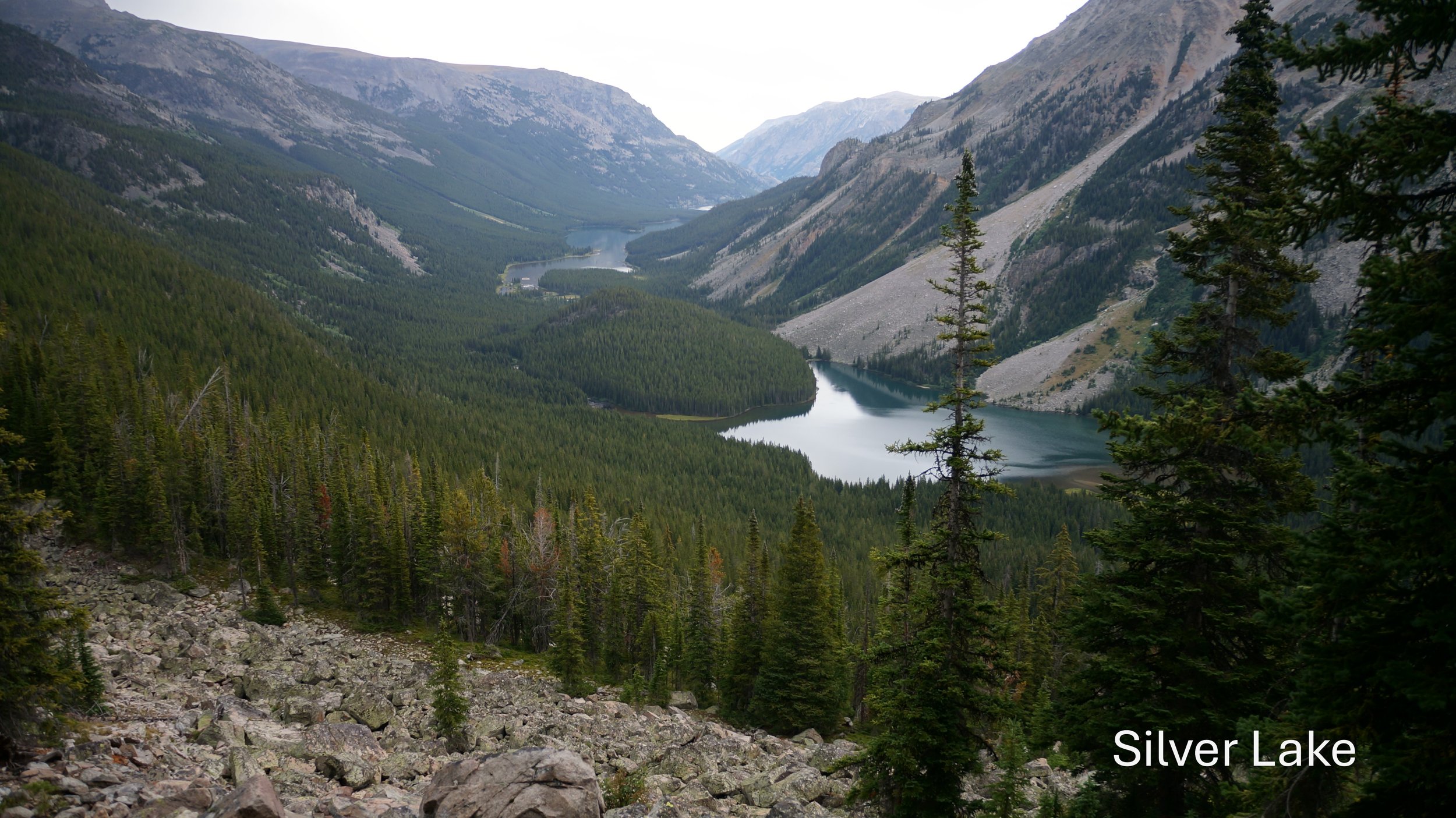 Mountain valley with a lake, dense forest, rocky terrain, and "Silver Lake" text.