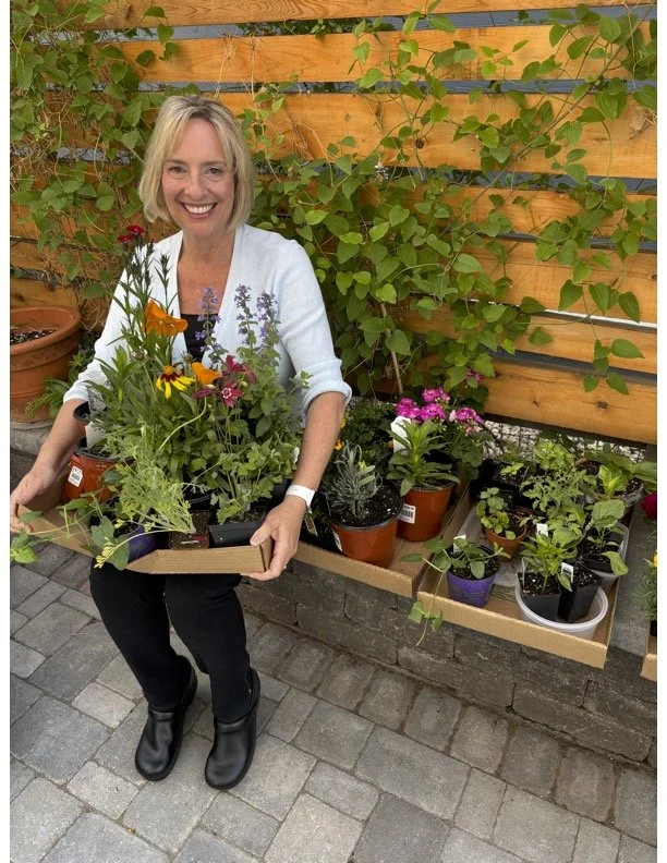 Elaine Belansky sitting on her patio preparing for retirement, surrounded by flowers.