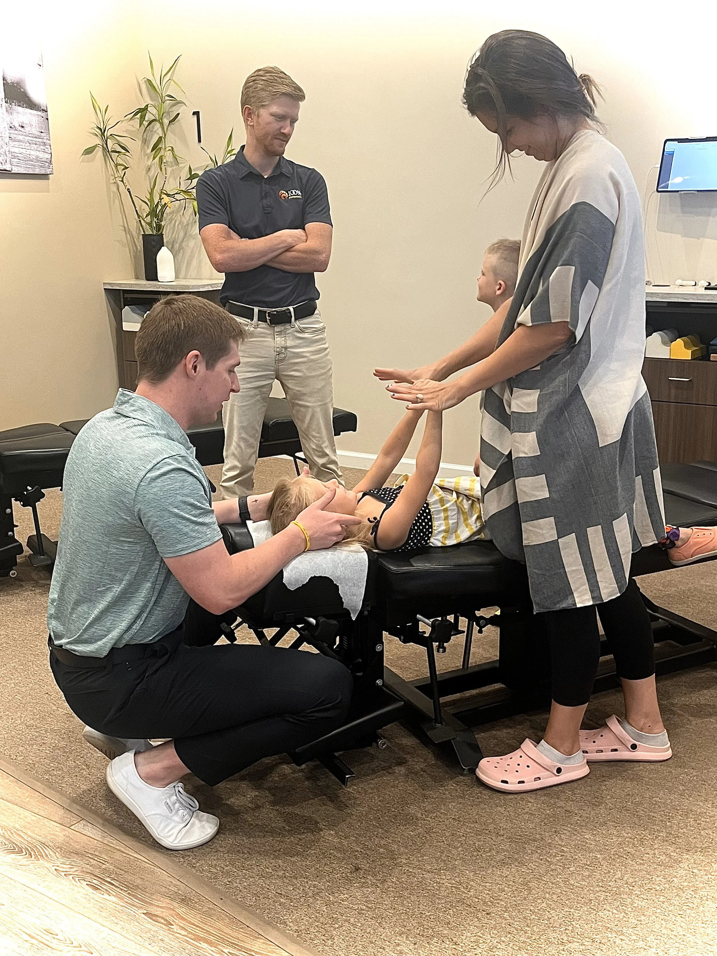Chiropractor performing a gentle pediatric adjustment on a patient at radiant chiropractric