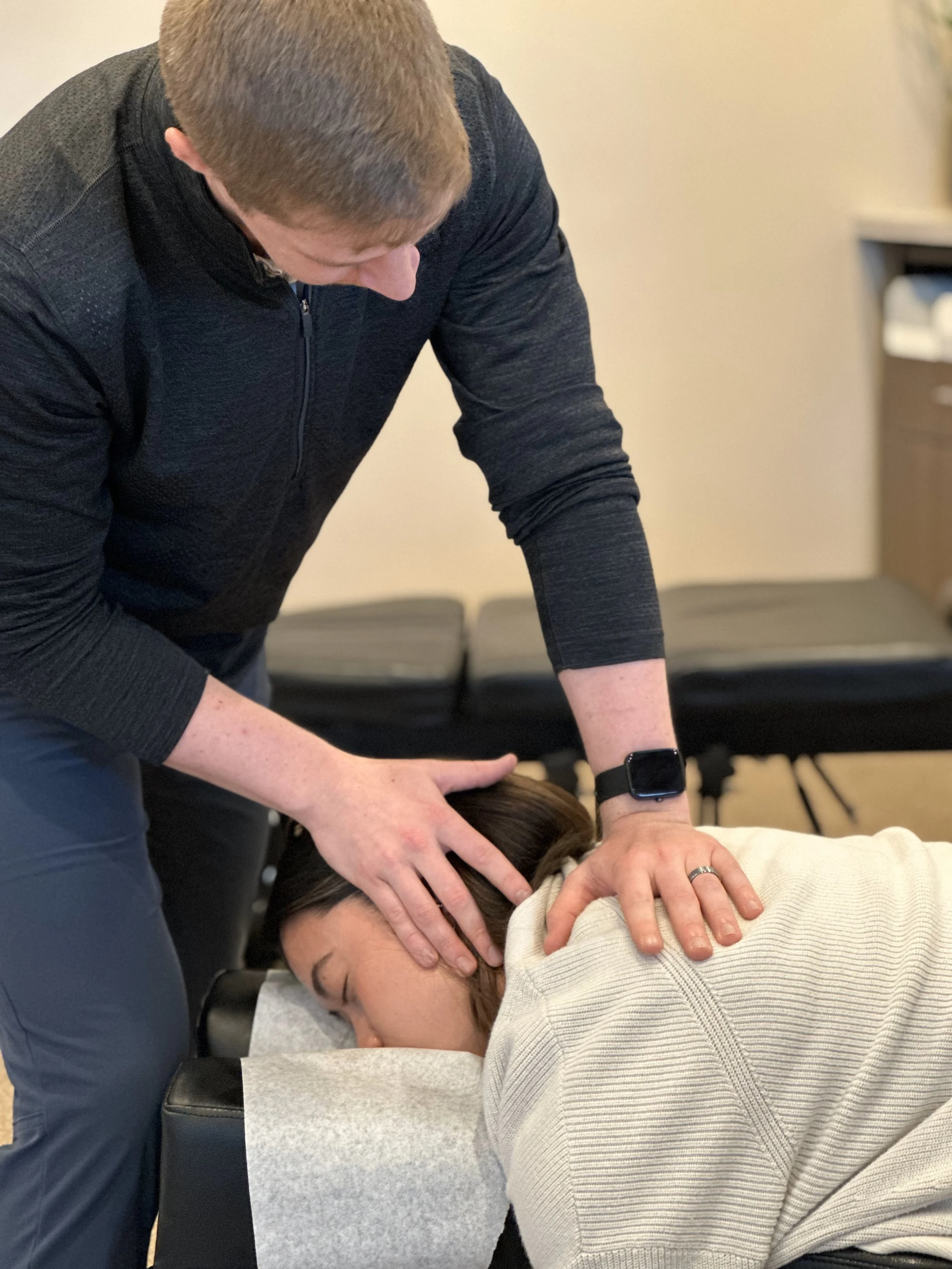Dr. Cameron giving patient a gentle neck adjustment for neck pain relief