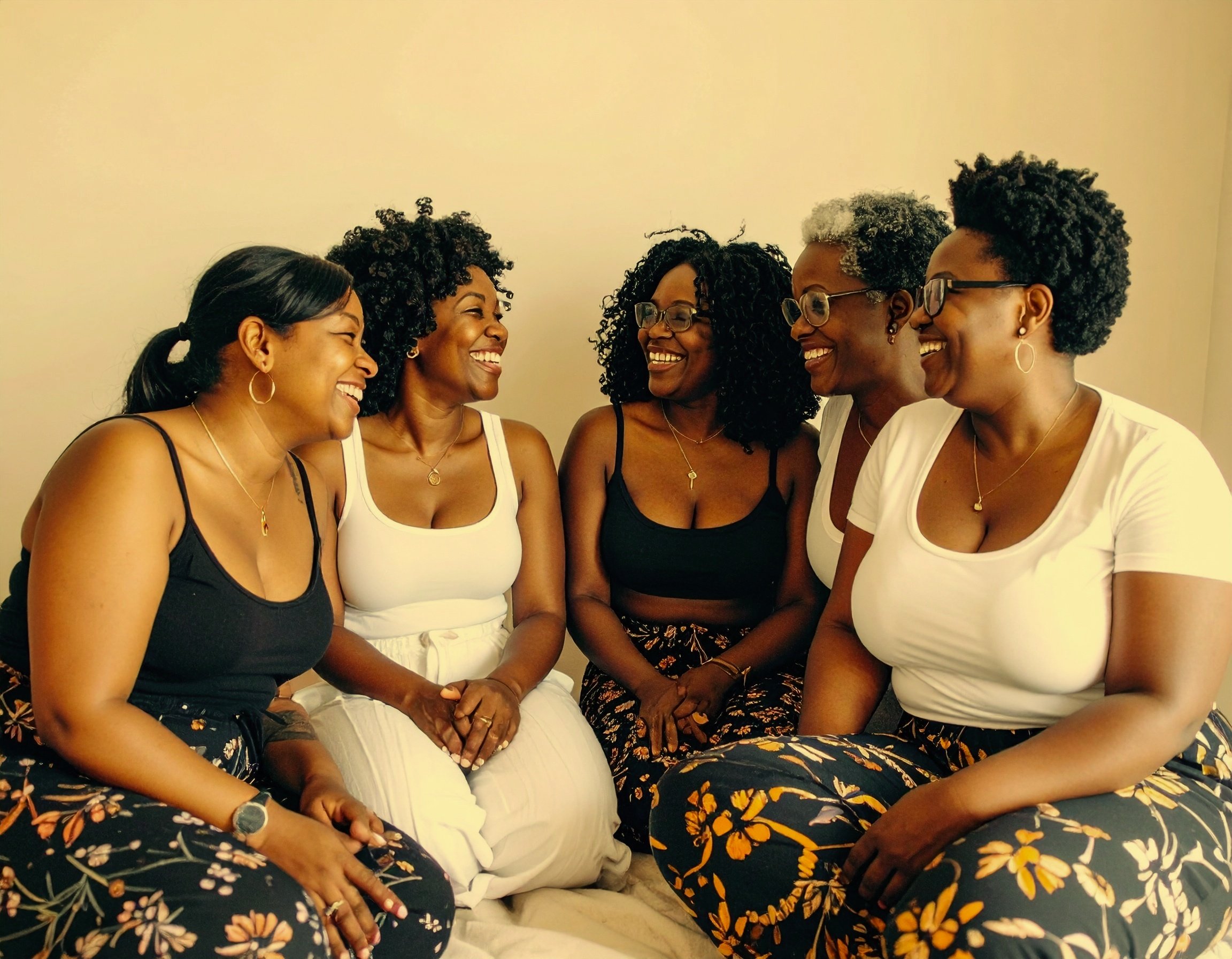 Firefly_a+warm+hued+image+of+black+women+of+various+skin+tones+sitting+in+a+circle+supporting+764800.jpg