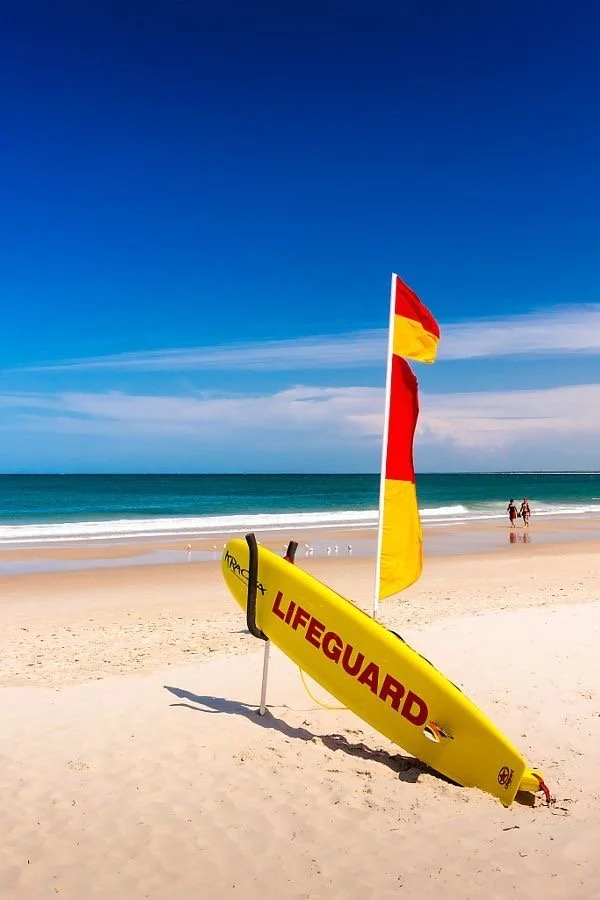 Lifesaving equipment and beach safety flags on the coast