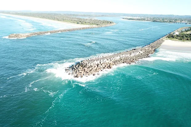 Aerial view of a coastal river or harbour entrance