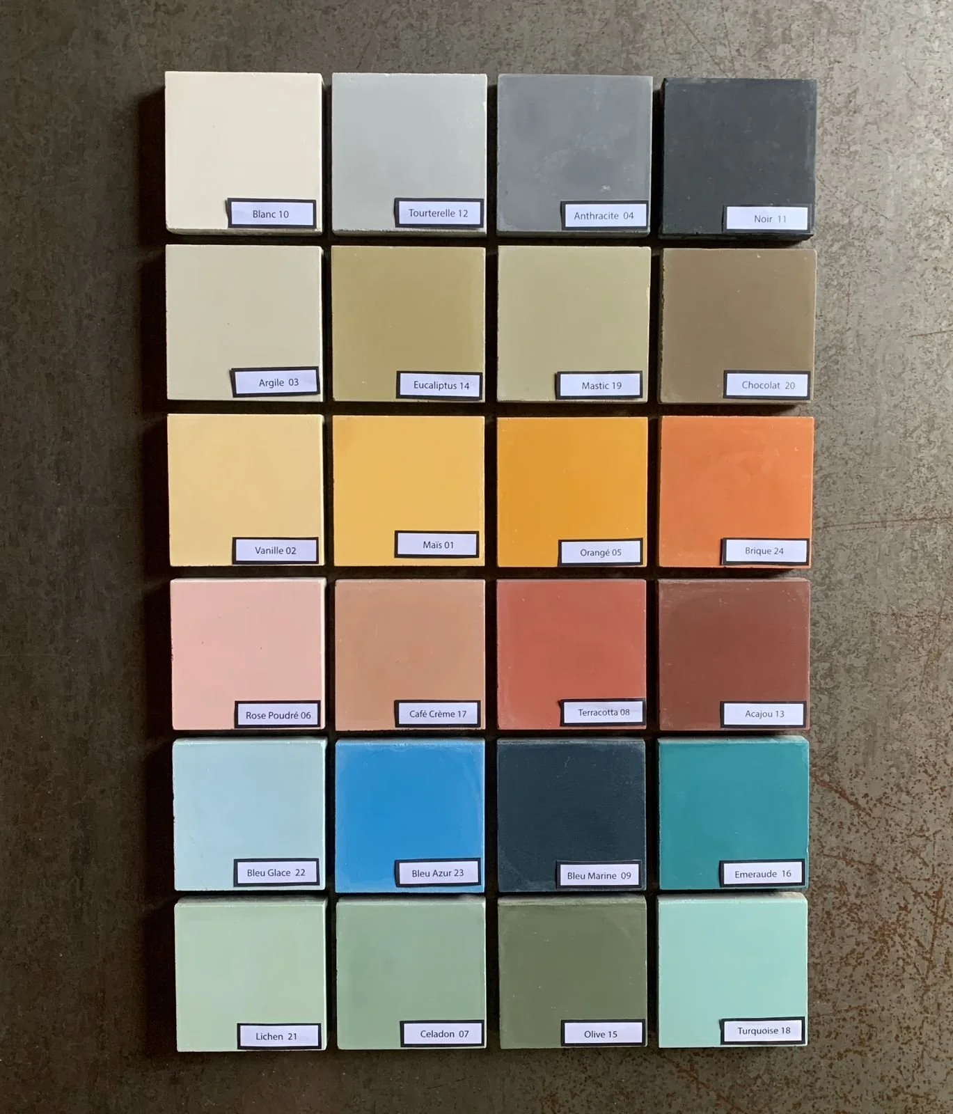 Color swatch palette with 20 rectangular paint samples arranged in four rows and five columns, each labeled with a color name and number.