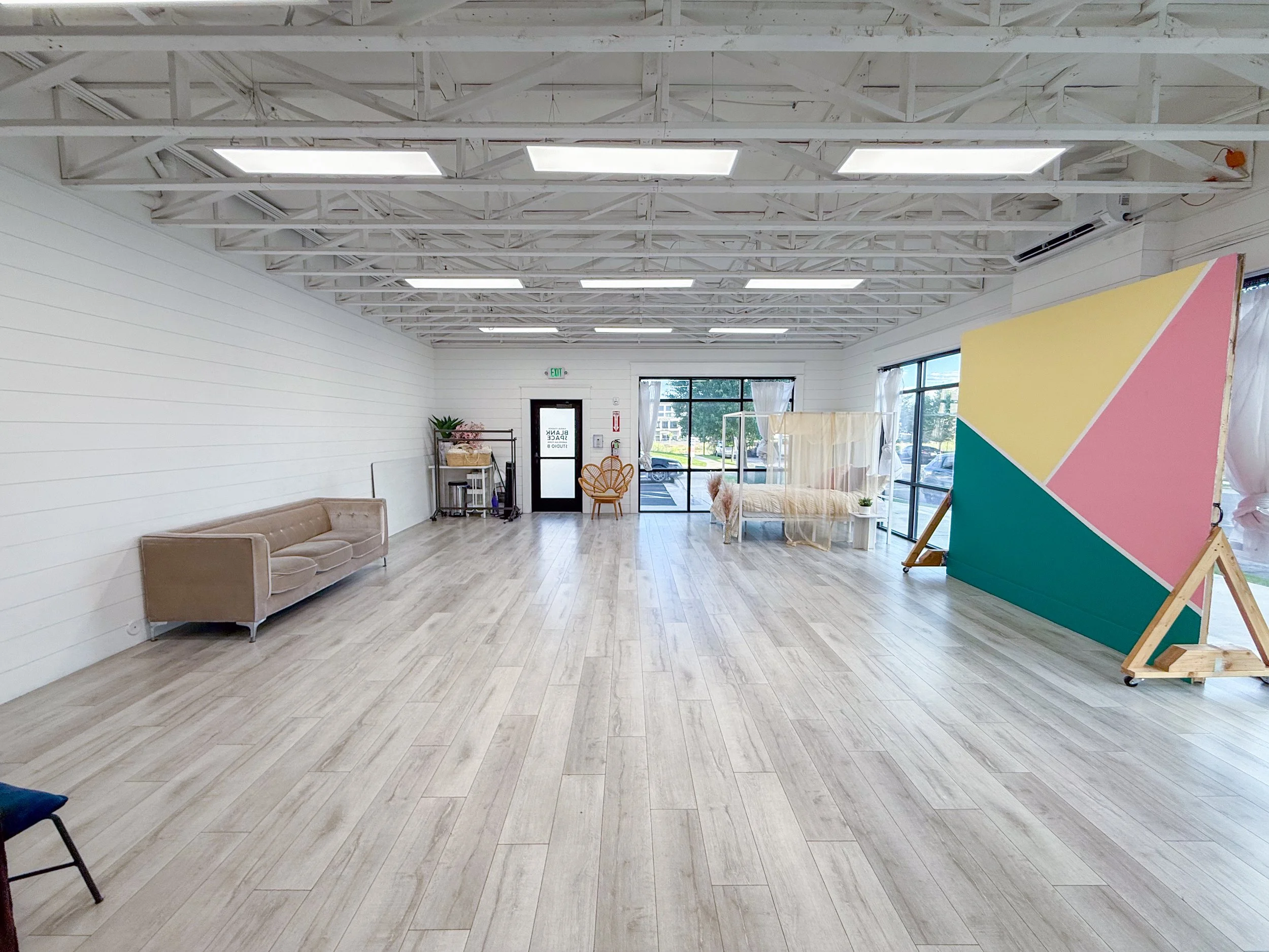 Versatile photography studio featuring lifestyle furniture, feature walls, natural light, and multiple portrait setups. Ideal for family photographers, wedding photographers, content creators, influencers, business owners, and marketing professionals