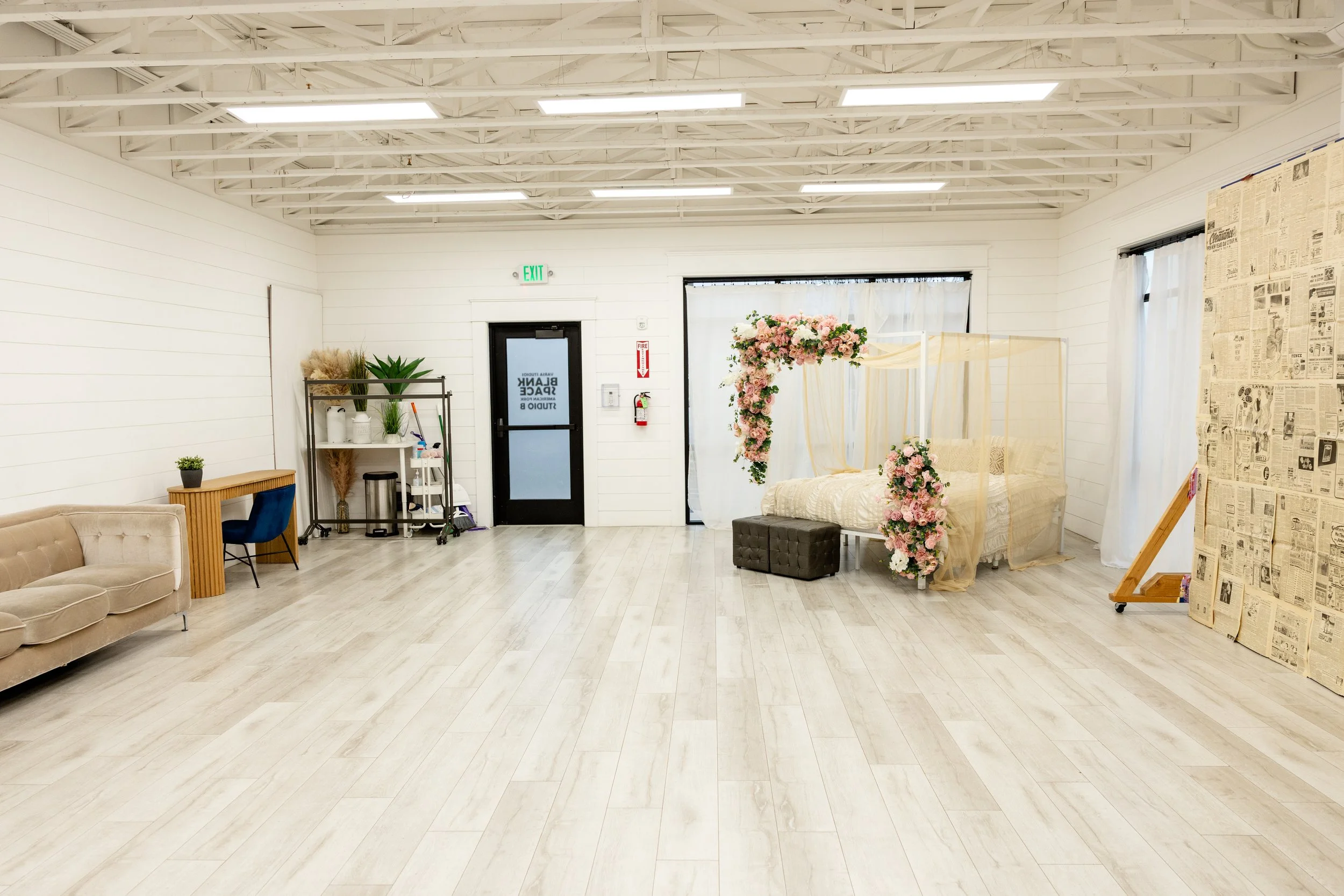 Elegant floral canopy bed backdrop in natural light photography studio in Utah County located in American Fork, perfect for maternity photography, boudoir sessions, branding photoshoots, romantic mini sessions and creative content studio rental.