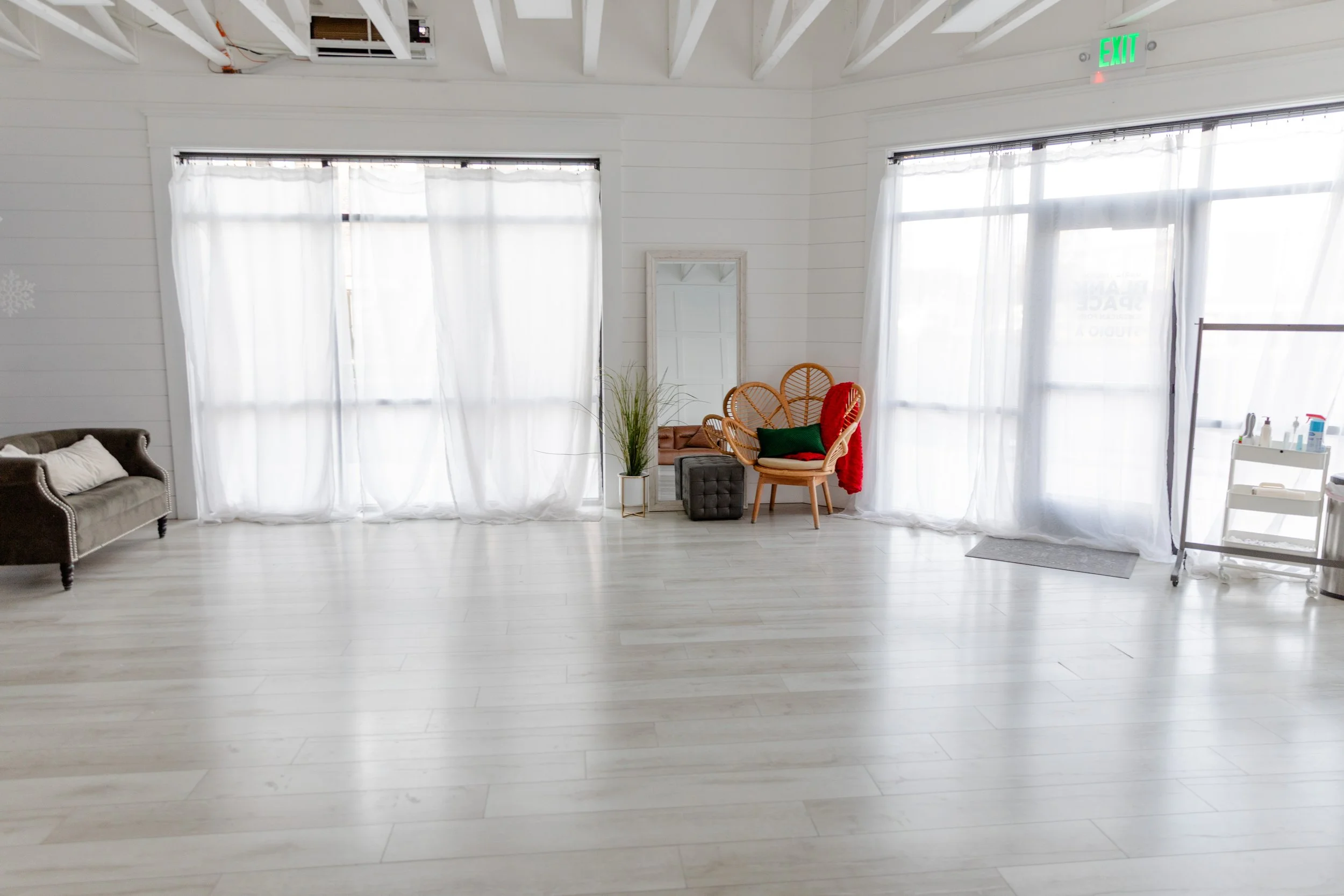 Studio A at Varsa Studios in American Fork, Utah, is a bright natural-light studio designed for photographers, videographers, and content creators. This clean, airy setup features white shiplap walls, sheer floor-to-ceiling curtains, and modern seati