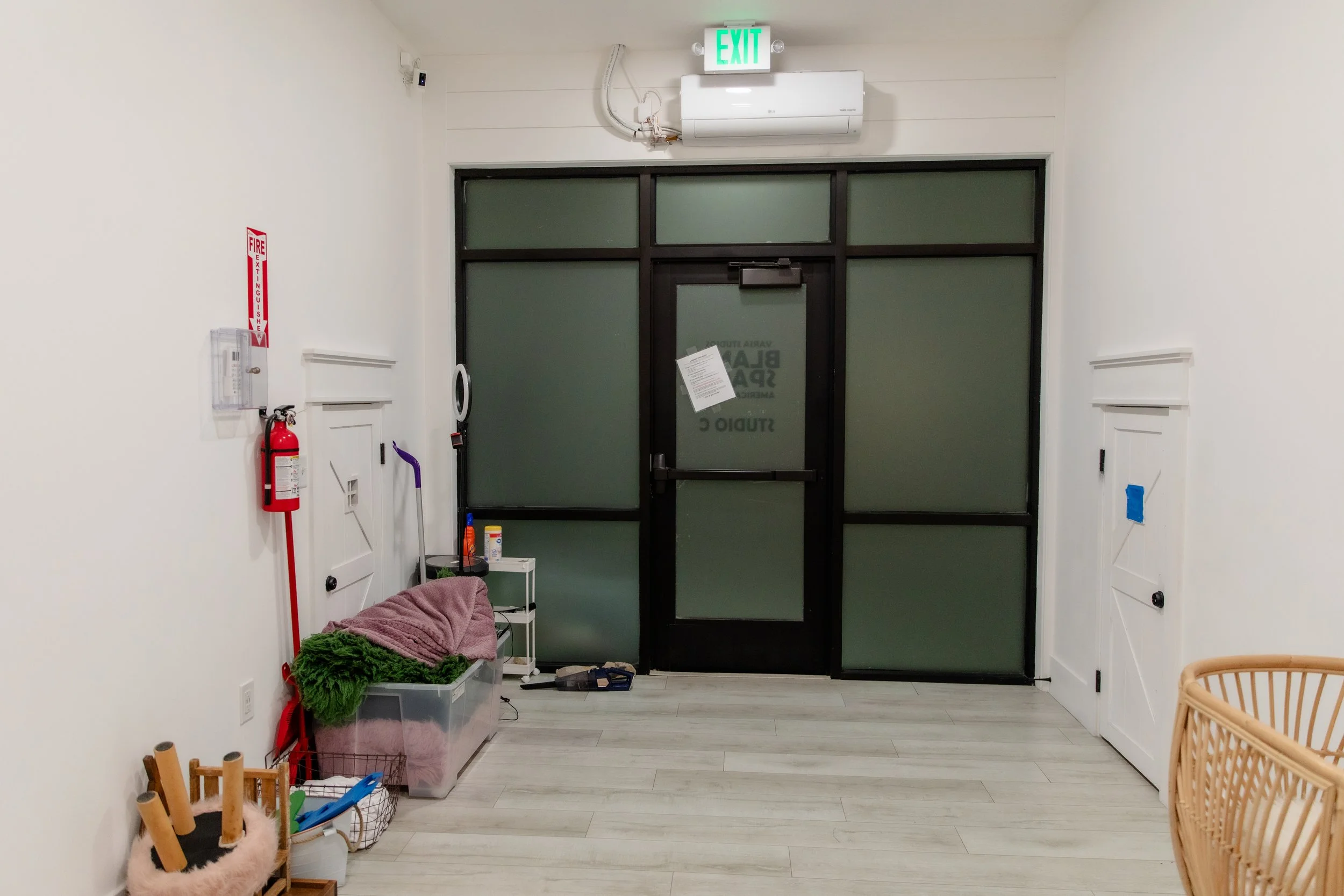 Entry view of Studio C newborn photography studio at Varsa Studios American Fork with neutral walls, soft seating, and a calm environment designed for newborn, baby, and family photo sessions.