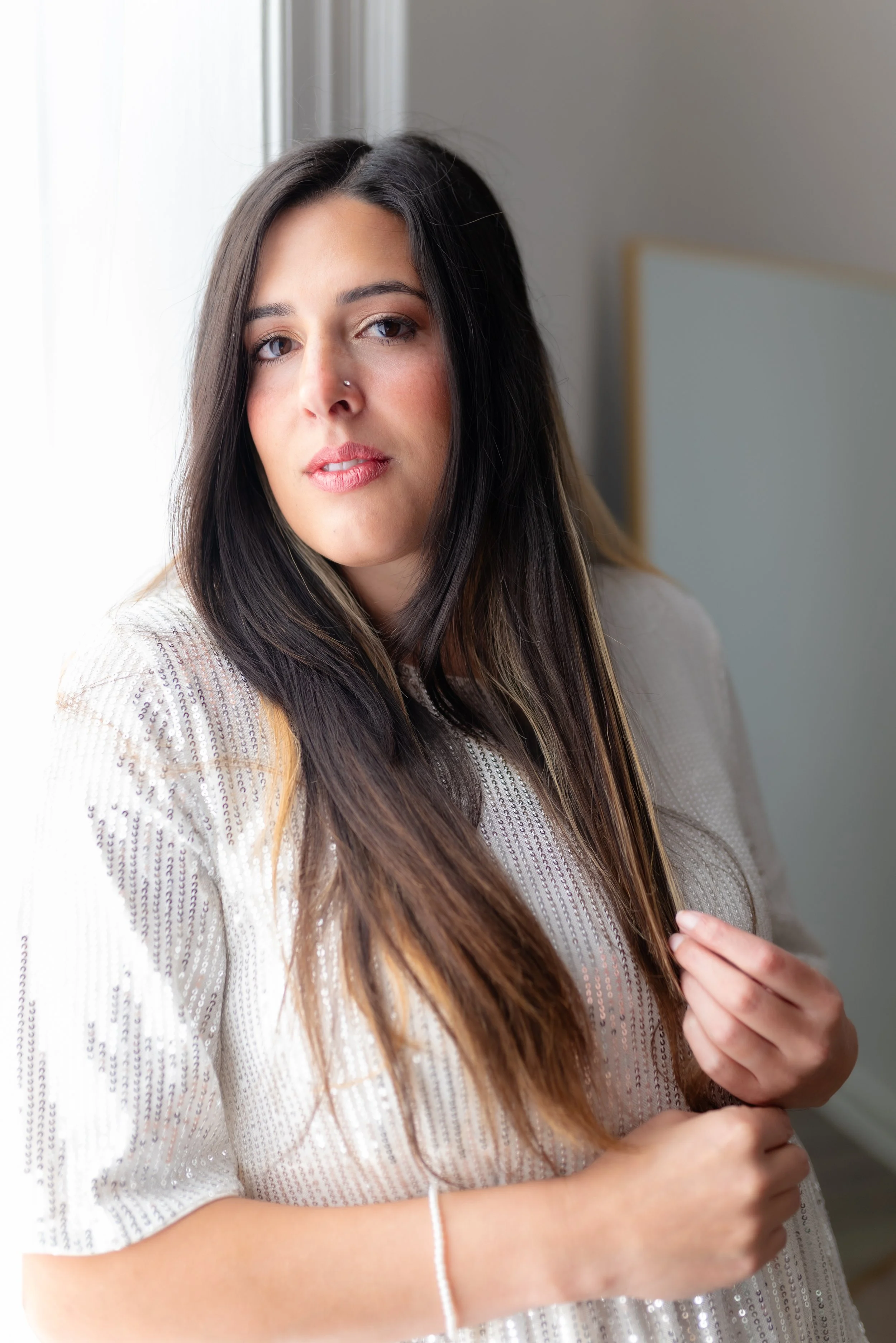 Studio owner in front of window