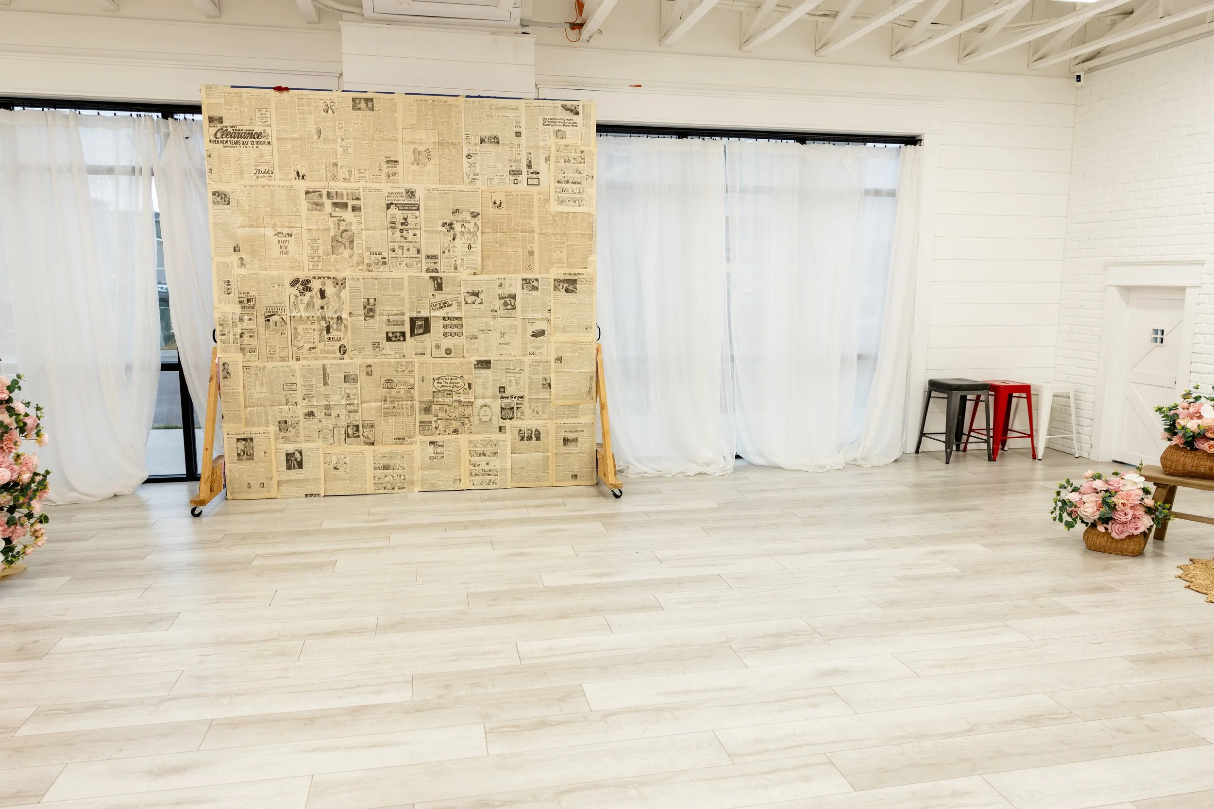 Creative backdrop wall made of vintage newspaper pages inside Studio A at Varsa Studios Blank Space American Fork Utah, unique photography studio rental in Utah County for senior portraits, branding sessions, editorial shoots, influencer content crea