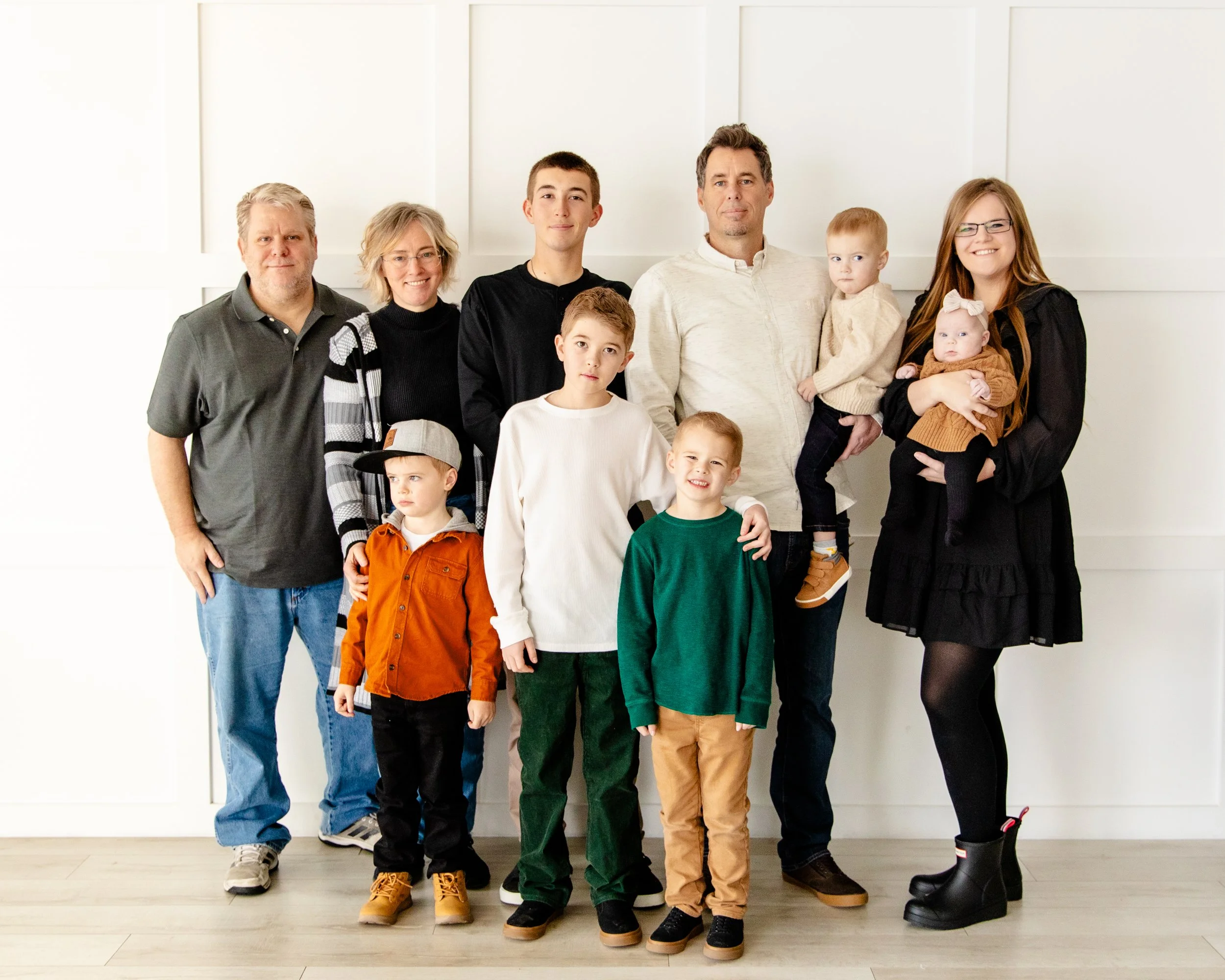 Extended family photos in a bright natural light Utah photography studio with white walls, perfect for family sessions and studio rentals.