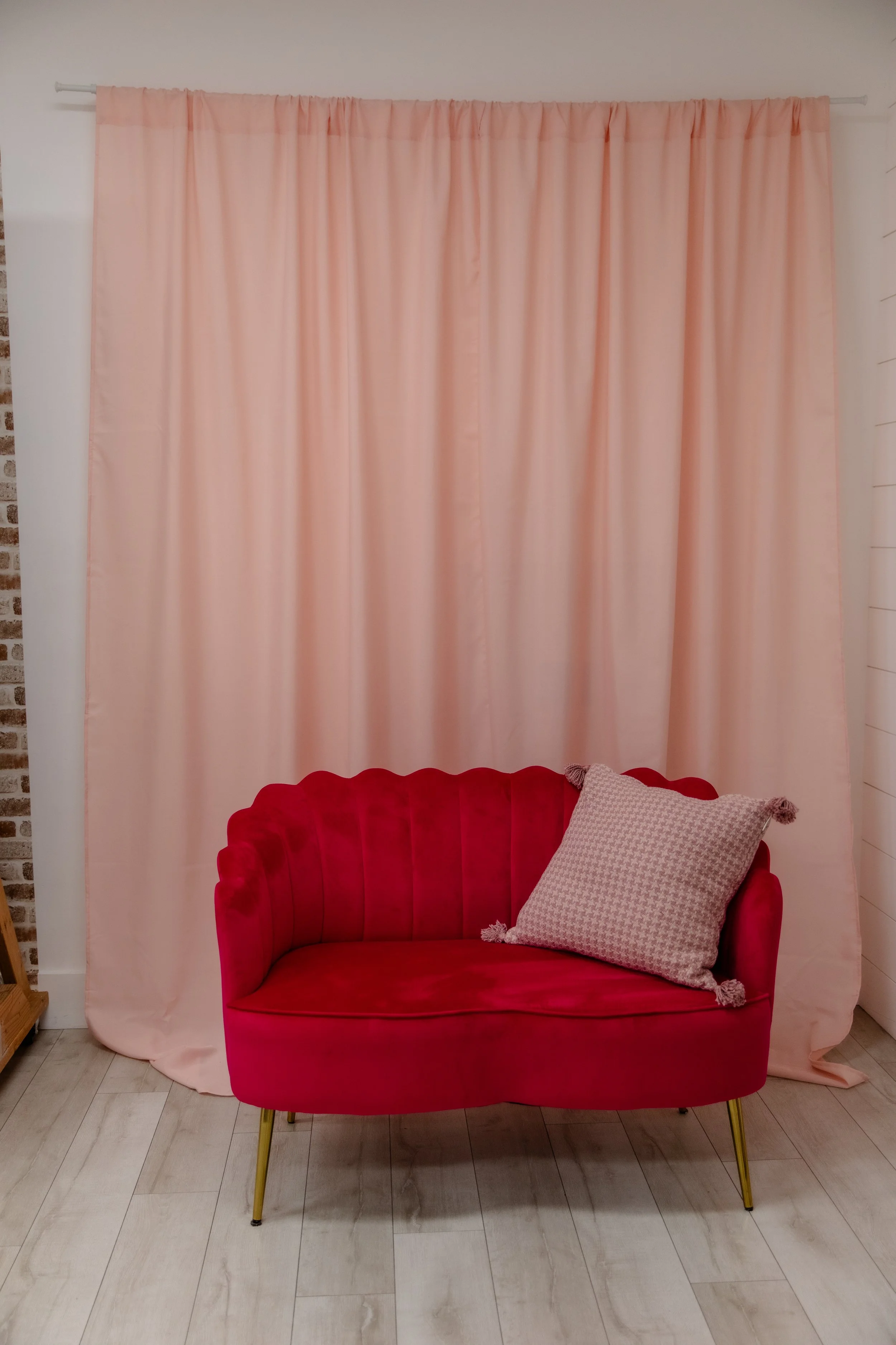 Pink curtain backdrop and Pink velvet couch in Studio A at Varsa Studios in American Fork, Utah, a bold Valentine’s Day and Mother’s Day setup for photographers, portrait sessions, and social media content creation.