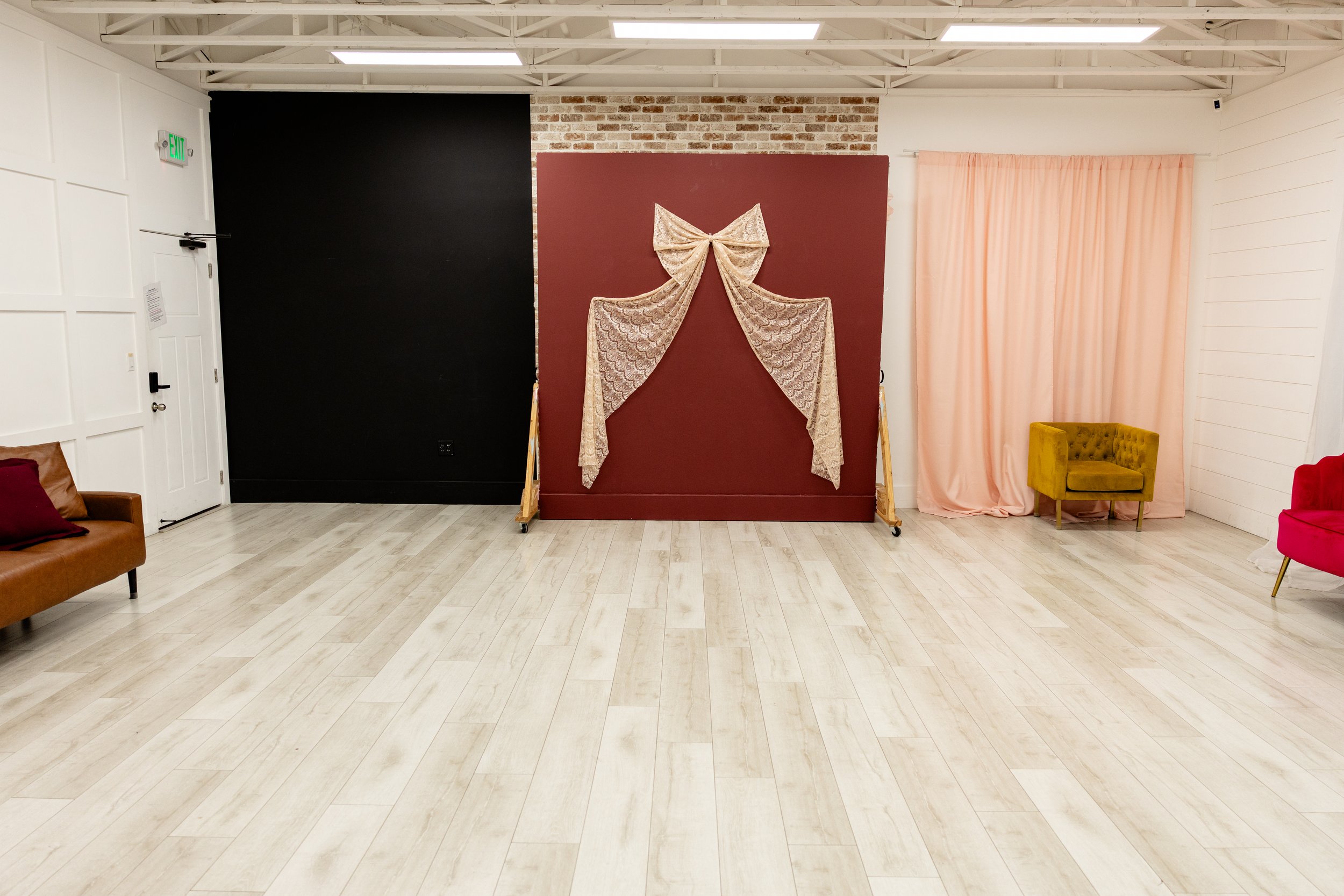 Studio A offers multiple shooting angles in one open concept space. The black accent wall provides contrast for dramatic portraits, while the exposed brick detail and neutral tones allow for both light and moody photography styles. This versatile pho