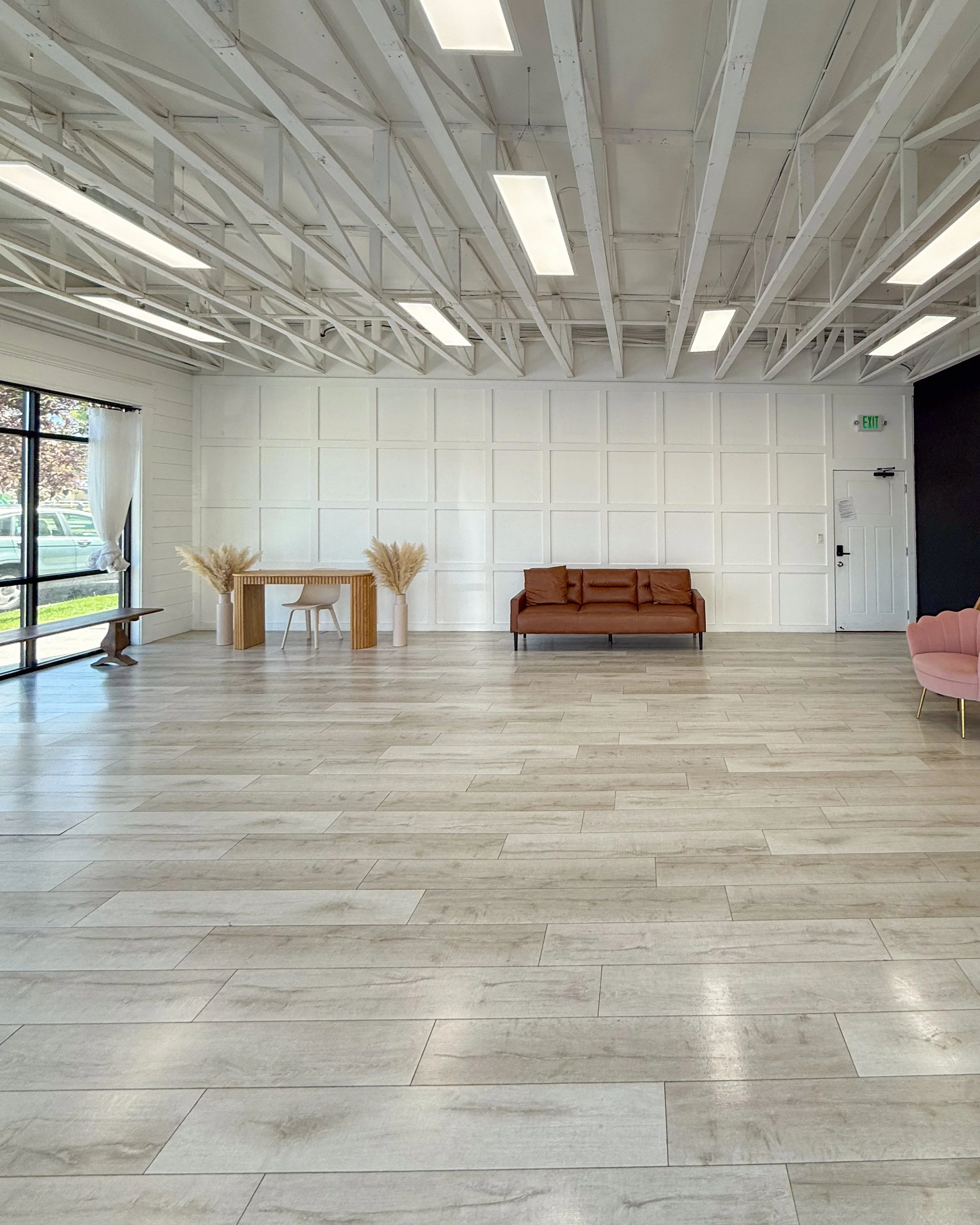 Studio A at Varsa Studios, located inside Blank Space in American Fork, Utah, features expansive floor to ceiling windows with sheer curtains that create beautiful soft natural light all day long. This bright and airy natural light studio in Utah Cou