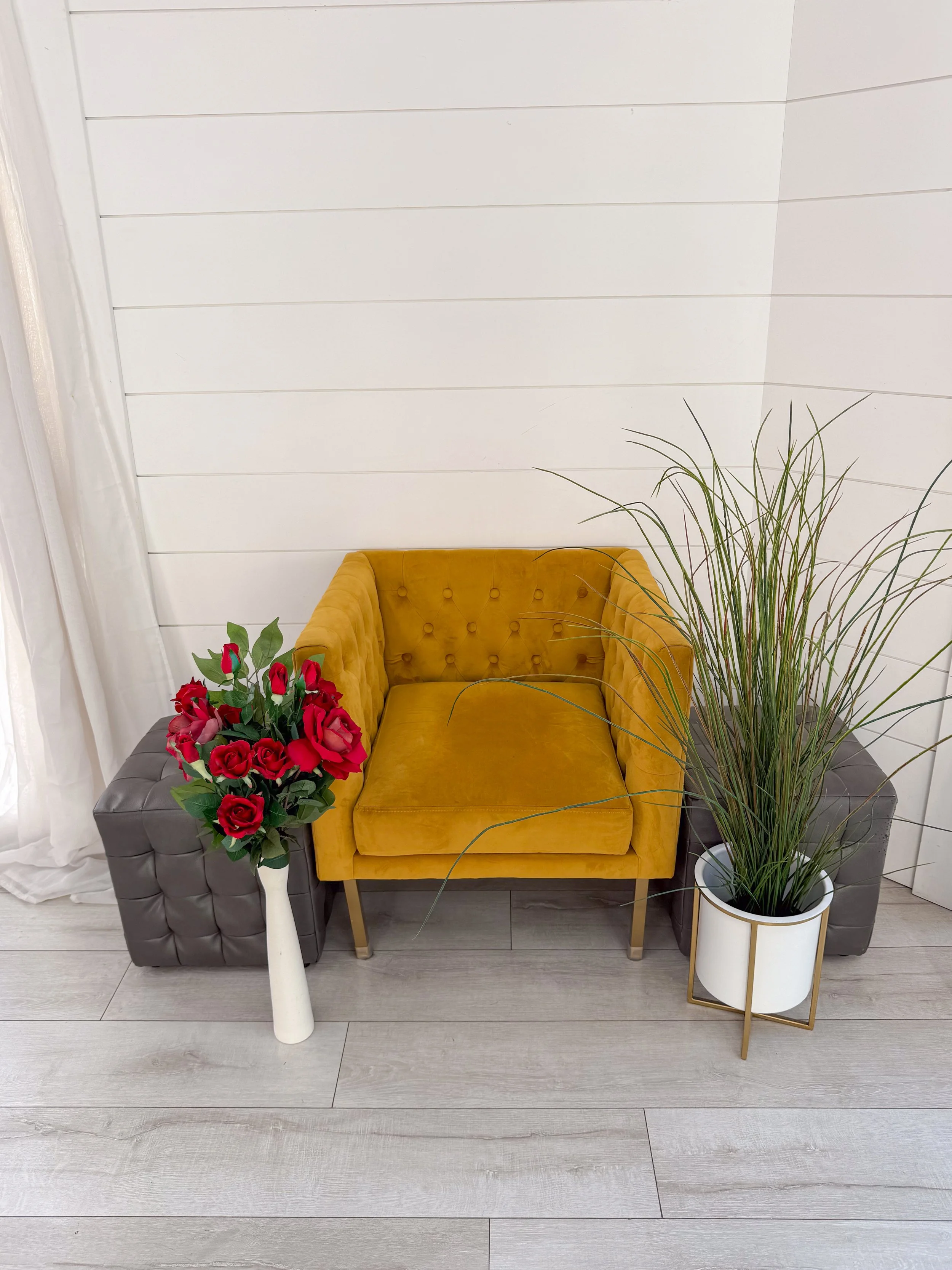 Stylish portrait corner featuring a mustard velvet chair, decorative greenery, florals, and a bright white shiplap wall. Ideal for branding sessions, senior portraits, lifestyle photography, business content, headshots, and influencer photography. Av