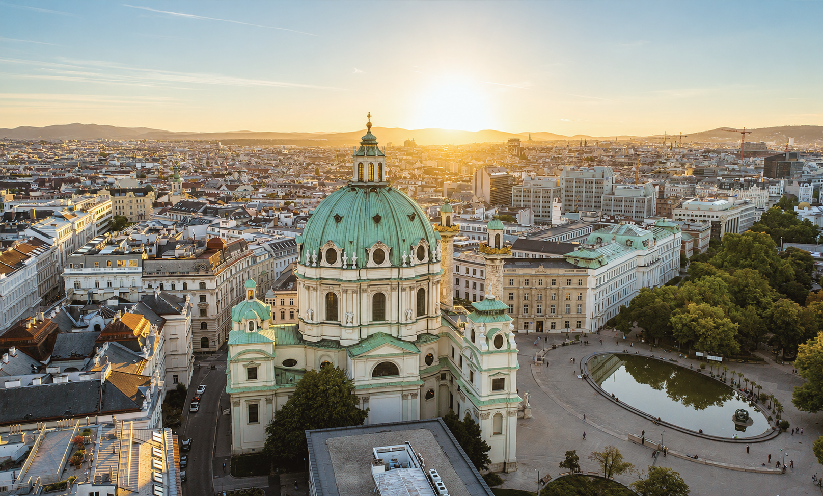 Elevated sunset view overlooking Karlskirche and the historic rooftops of Vienna