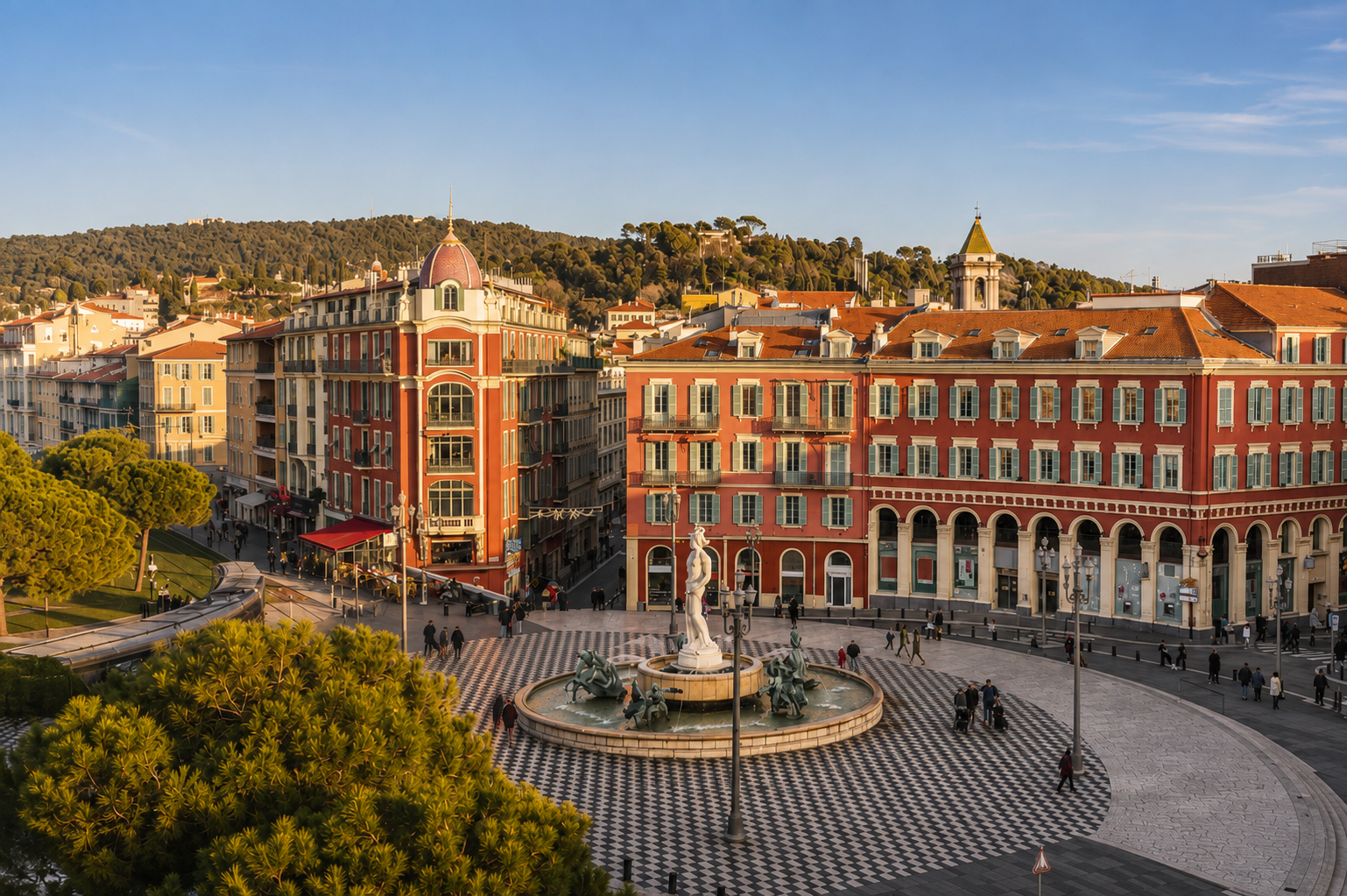 Place Masséna in Nice, France, with its colorful historic architecture, fountain, palm trees, and Mediterranean cityscape.