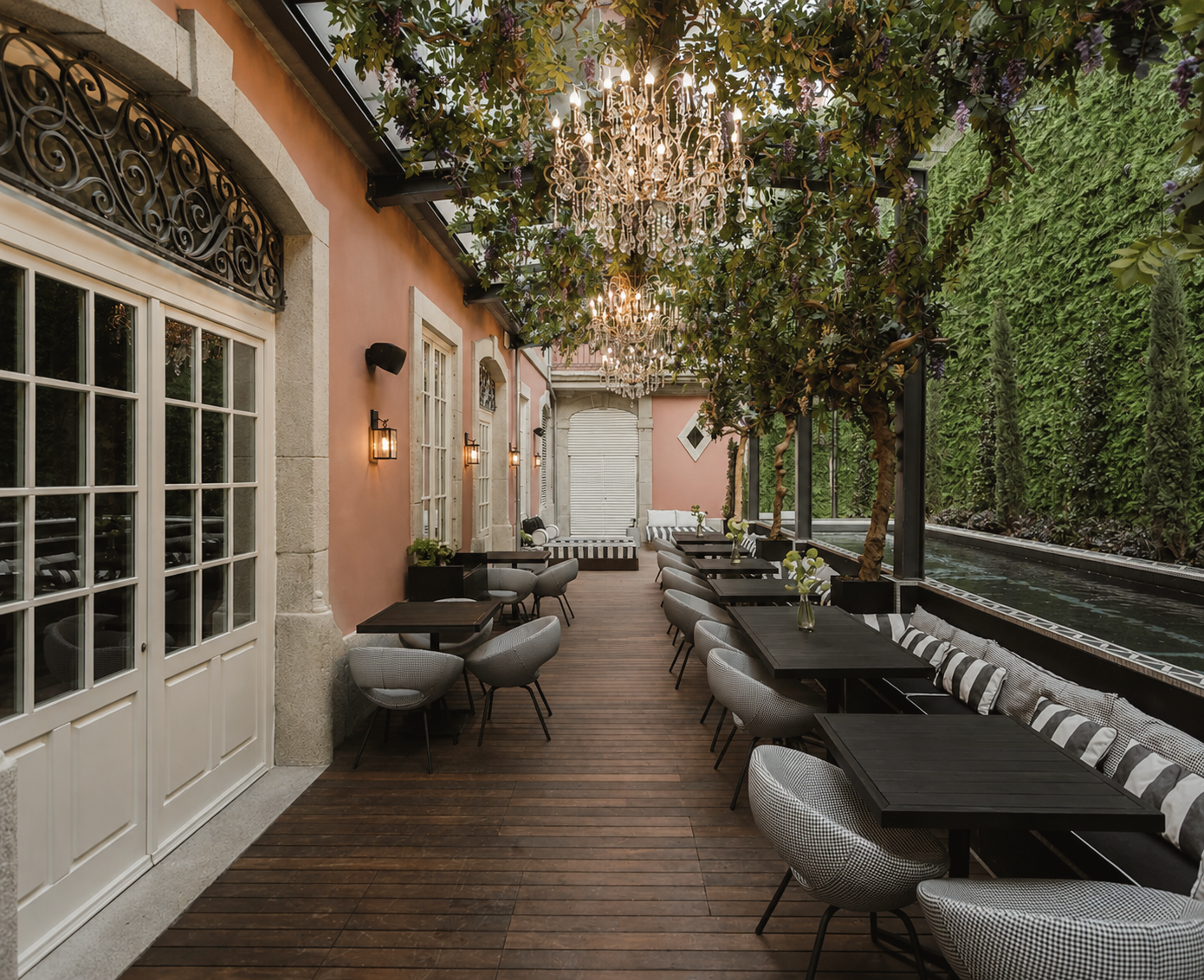 Torel Palace Porto luxury boutique hotel in Porto, Portugal, featuring an elegant garden terrace with chandeliers, stylish seating, and a refined historic atmosphere.