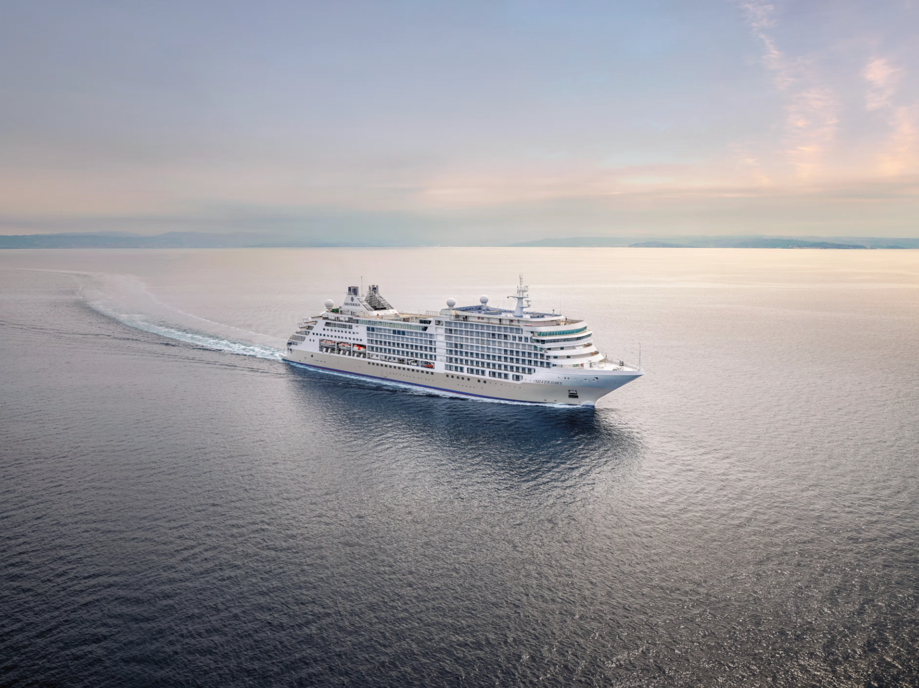 Silversea luxury cruise ship sailing at sea, offering an upscale all-inclusive ocean voyage experience.