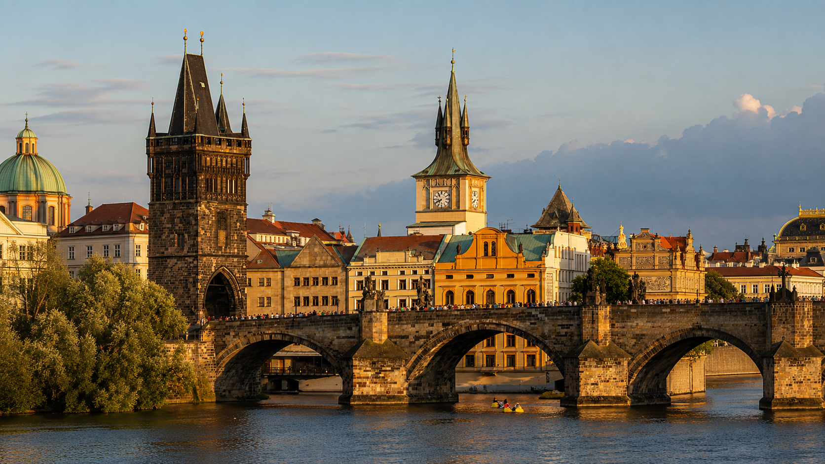 Charles Bridge in Prague, Czech Republic, spanning the Vltava River with the Old Town Bridge Tower and historic Prague skyline in warm evening light.