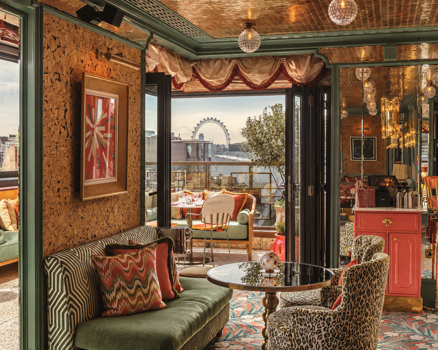 Rooftop lounge at Broadwick Soho, a luxury boutique hotel in London, featuring eclectic interiors, velvet seating, rich patterned furnishings, and views of the London Eye.