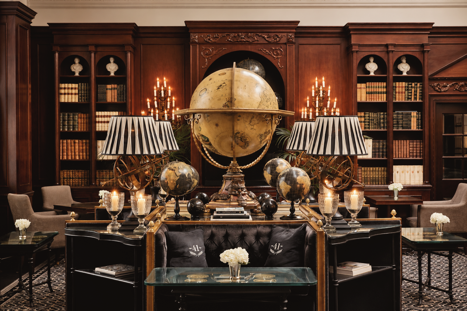 Elegant executive lounge at Hotel 41, a luxury five-star boutique hotel in London, England, featuring rich wood-paneled bookshelves, a grand antique globe, sophisticated furnishings, and warm candlelit interiors.