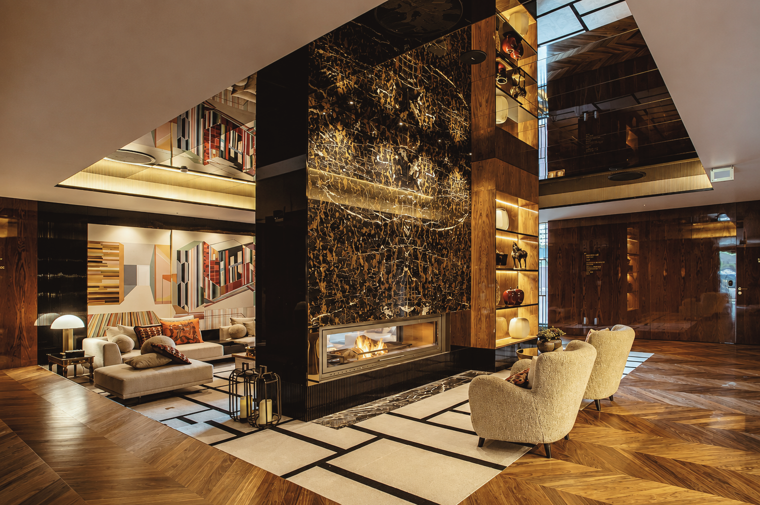 Vinha Boutique Hotel in Porto, Portugal, featuring a luxurious contemporary lounge with fireplace, rich wood finishes, curated artwork, and elegant designer furnishings.