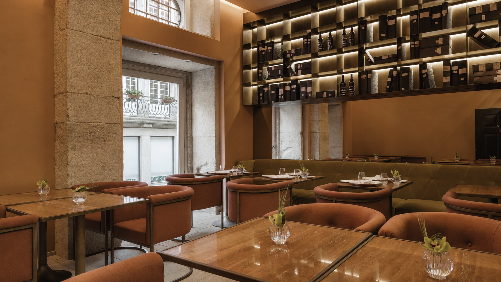 Casa da Companhia luxury hotel in Porto, Portugal, featuring a sophisticated restaurant interior with warm wood tones, elegant seating, and contemporary Portuguese design.