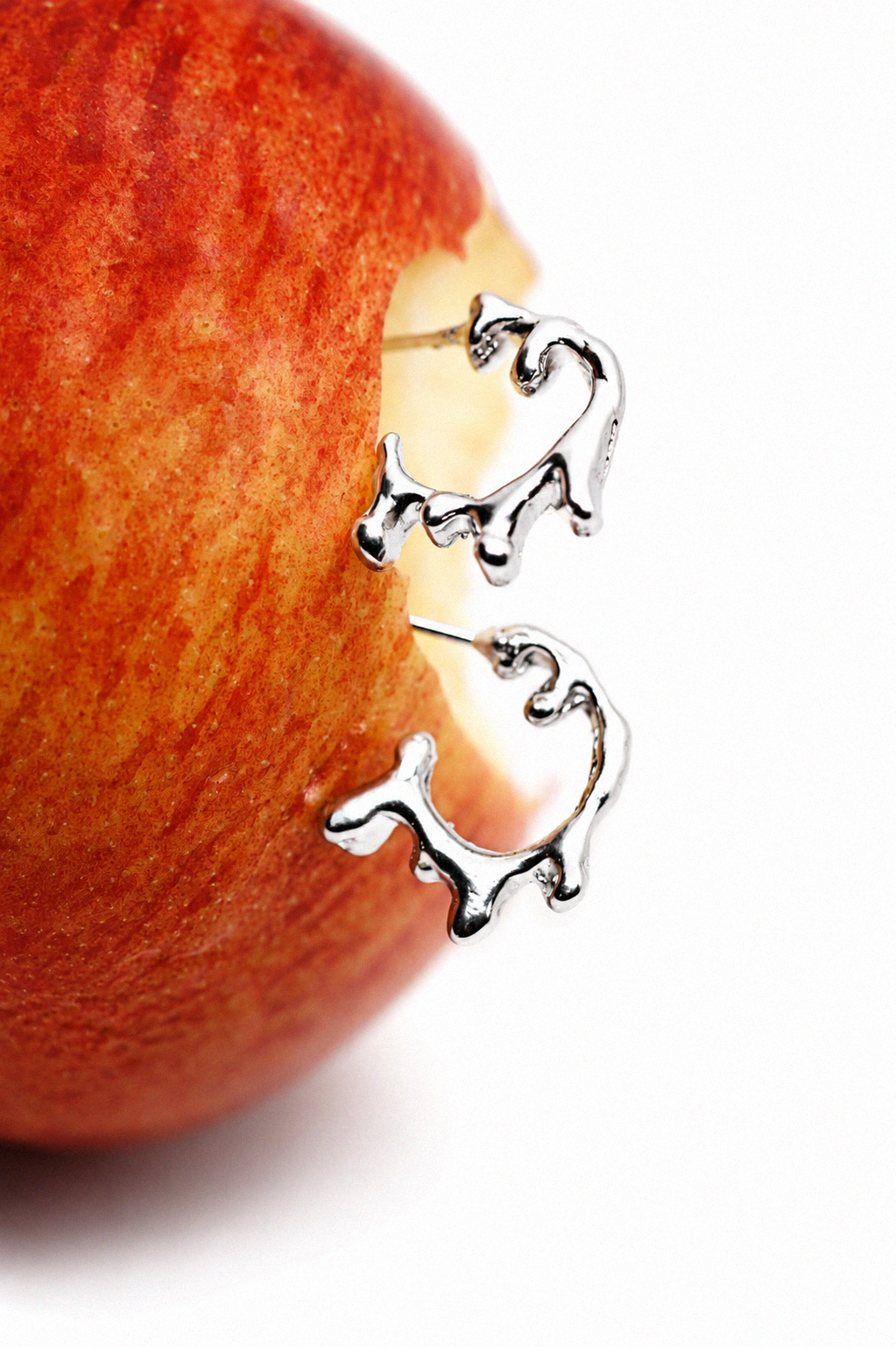 abstract-sterling-silver-earrings-on-red-apple.png