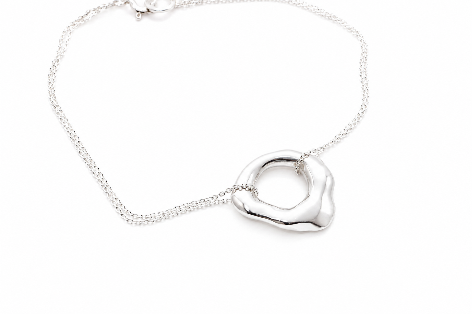 silver-organic-circle-pendant-bracelet-flat-lay.png
