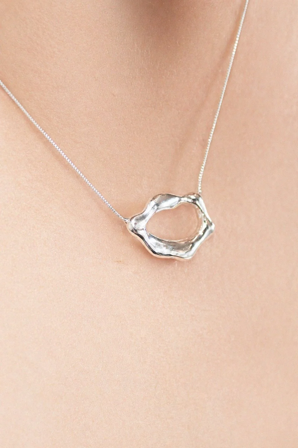 silver-organic-branch-hoop-earring-ear-through-torn-paper.png