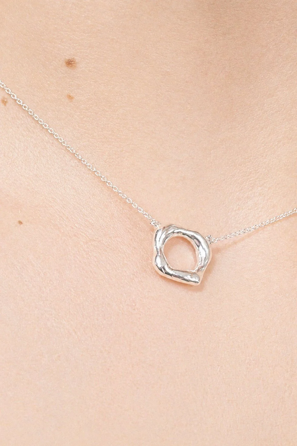 silver-double-open-oval-ring-on-hand-with-black-nails.png