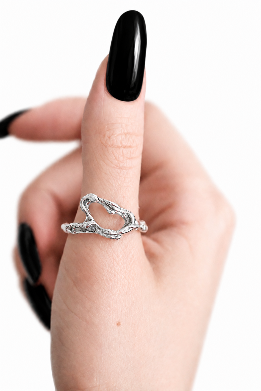 silver-heart-shaped-open-ring-on-finger.png