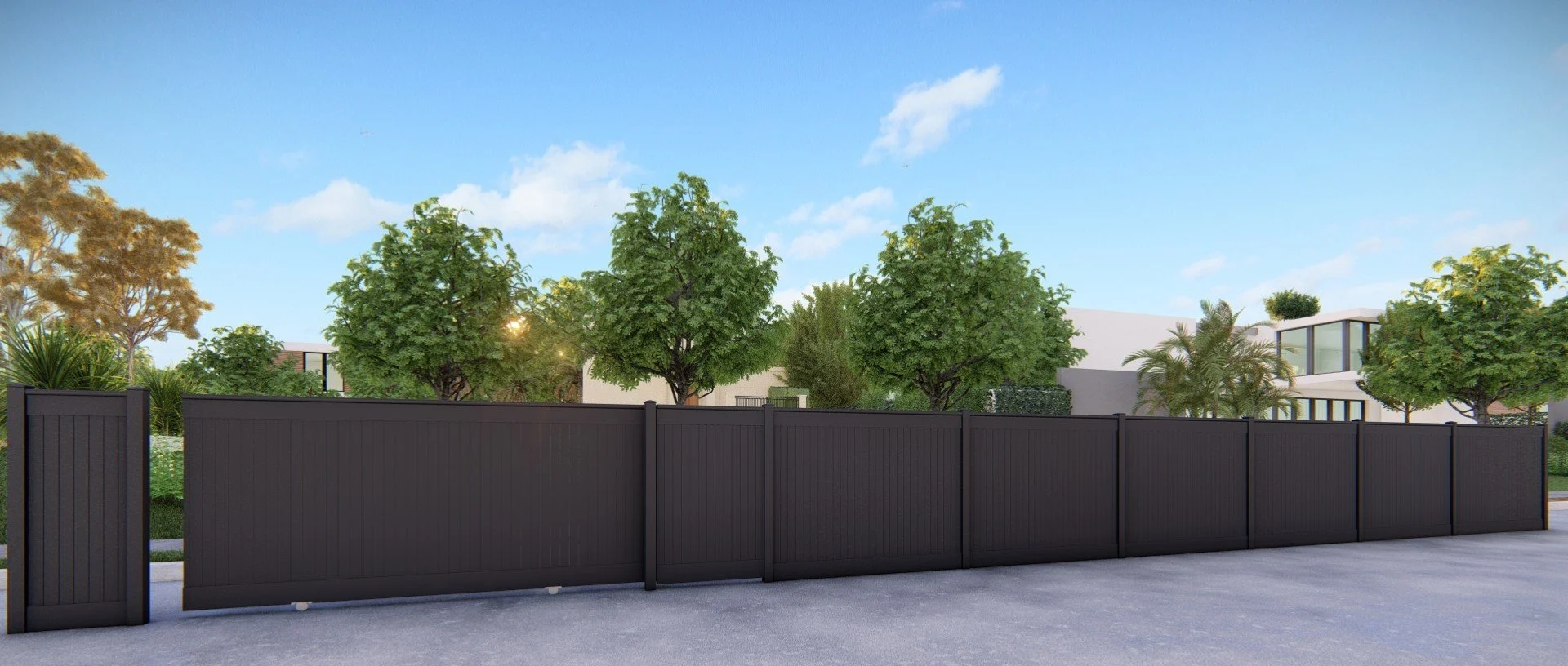 Modern black fence with trees and residential buildings behind it on a sunny day.