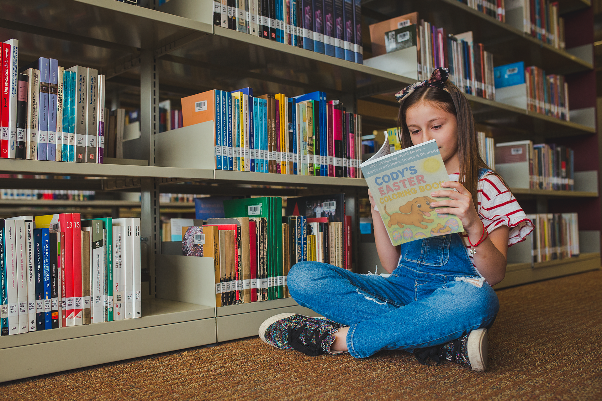 girl-sitting-with-crossed-legs-reading-a-book-mockup-at-the-library-a19270.png