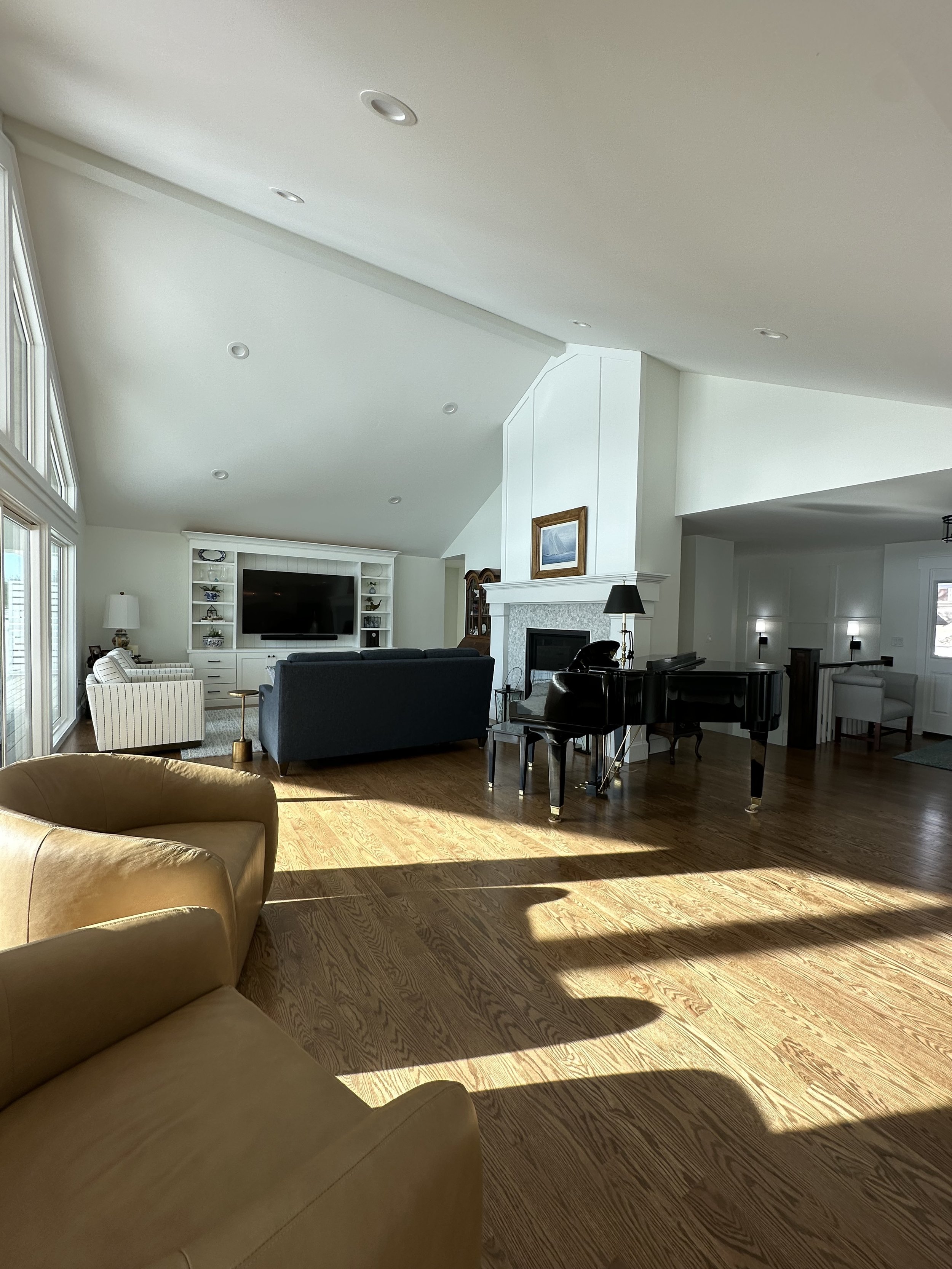 We gained space by removing the large brick fireplace and hearth replacing it with a gas insert. We vaulted the ceiling, removed the wall separating the kitchen and living room and added a doorway to the primary suite.