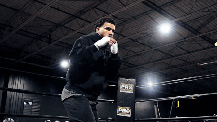 Professional boxer Cody Davis training in the ring with shadowboxing and heavy bag work