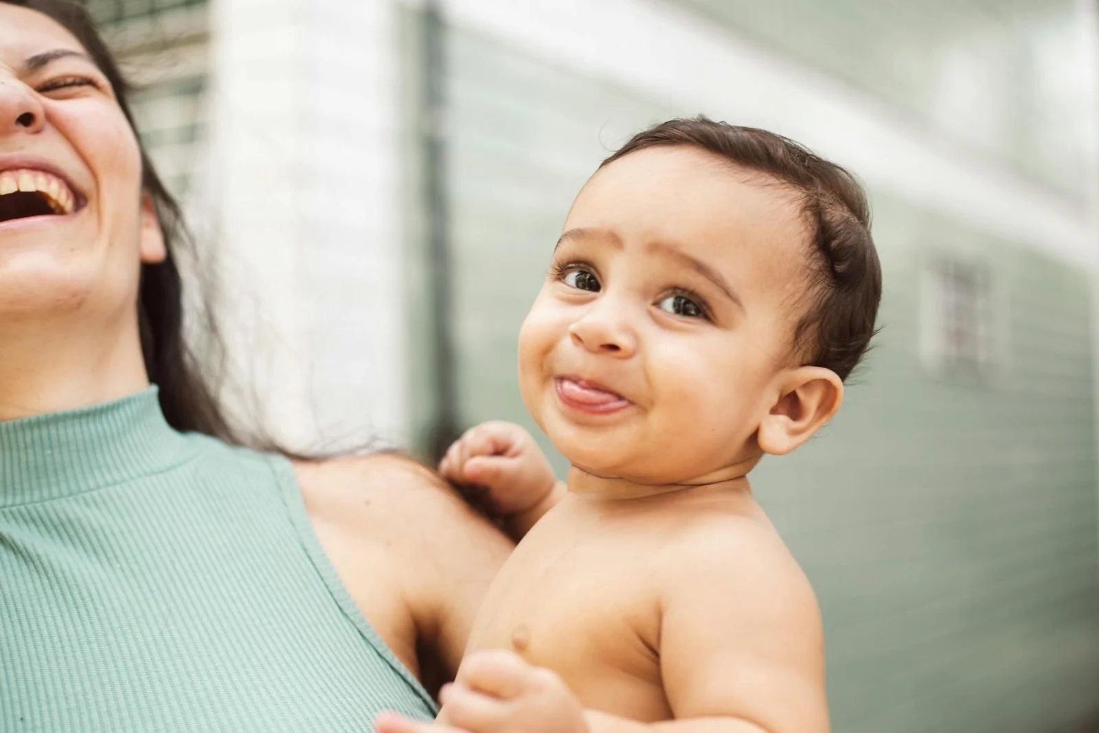 A-woman-holding-a-baby-and-laughing