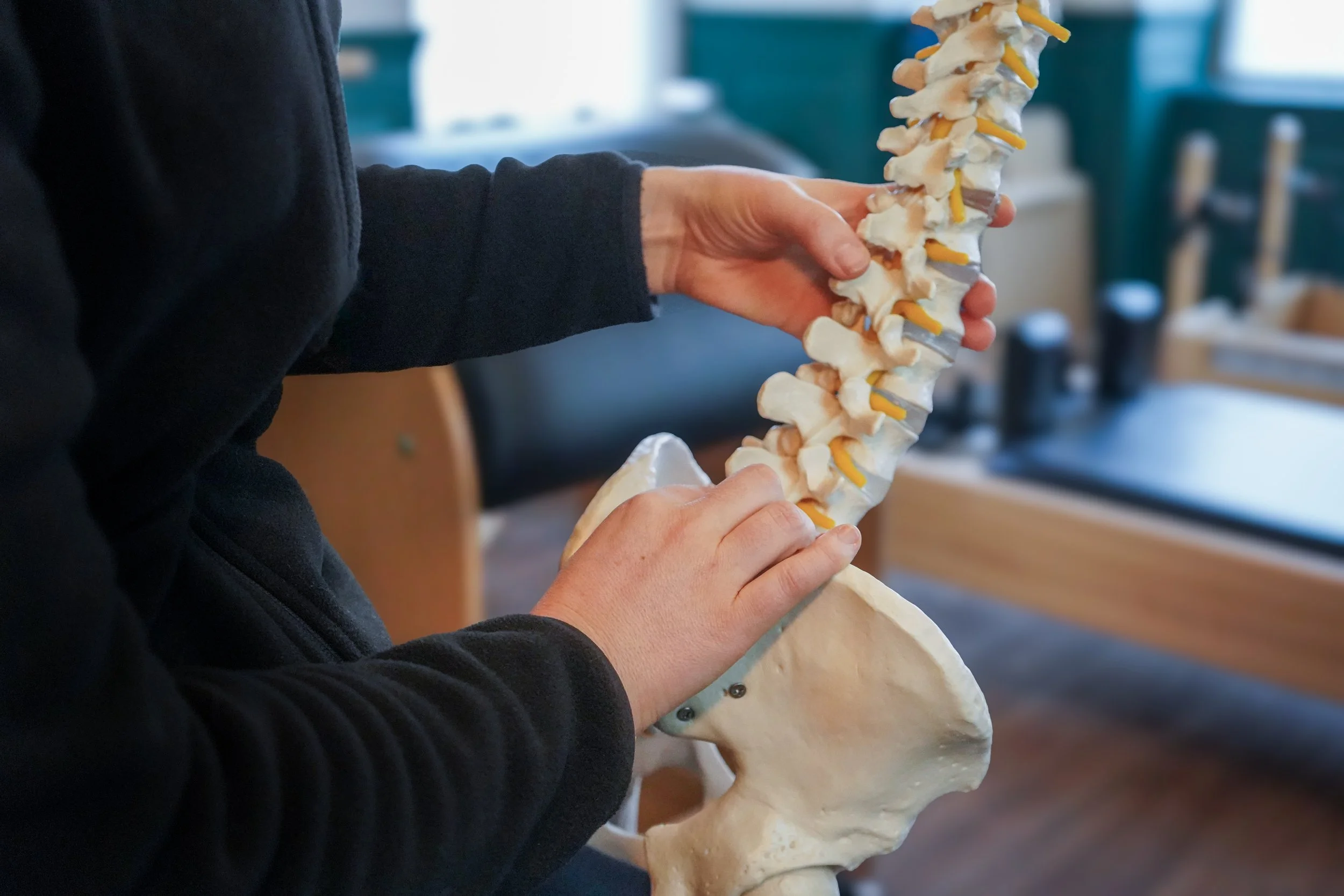 Person receiving a back massage with hands applying pressure.
