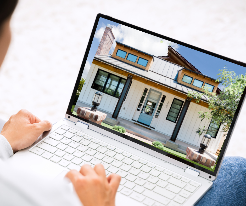 Person viewing a modern house design on a laptop screen.
