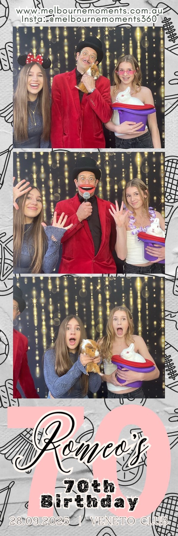 Three people celebrating a birthday, with a background of shiny gold lights. The man in the center is dressed as a circus performer or clown, wearing a red suit and a black hat, and holding a small orange guinea pig. The girl on the left is wearing a